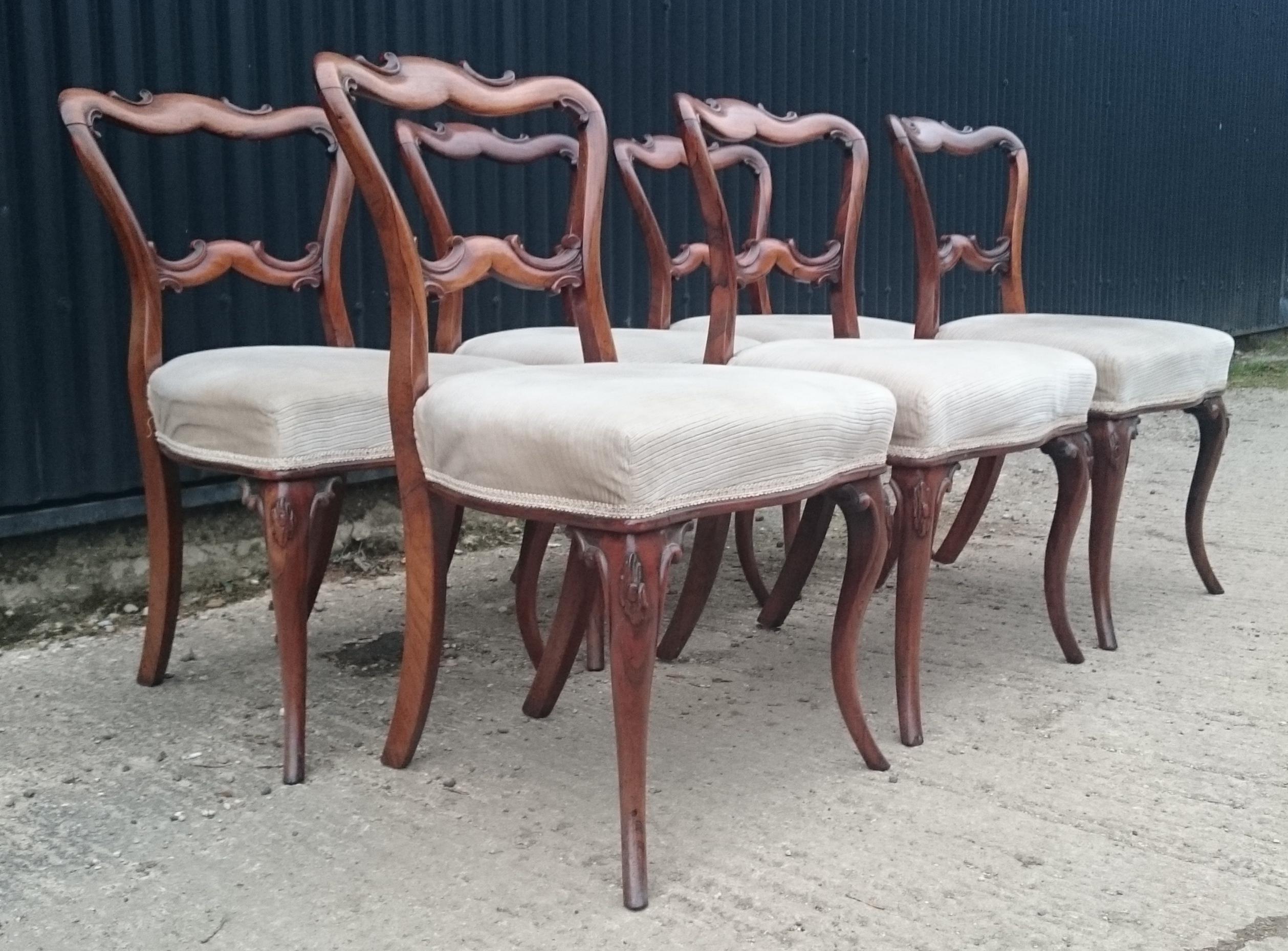 Set of six antique dining chairs standing on elegant cabriole legs. These chairs have the earlier type of corner stretchers which would indicate that they are an early version of this design. This is a very Fine quality set of chairs and the