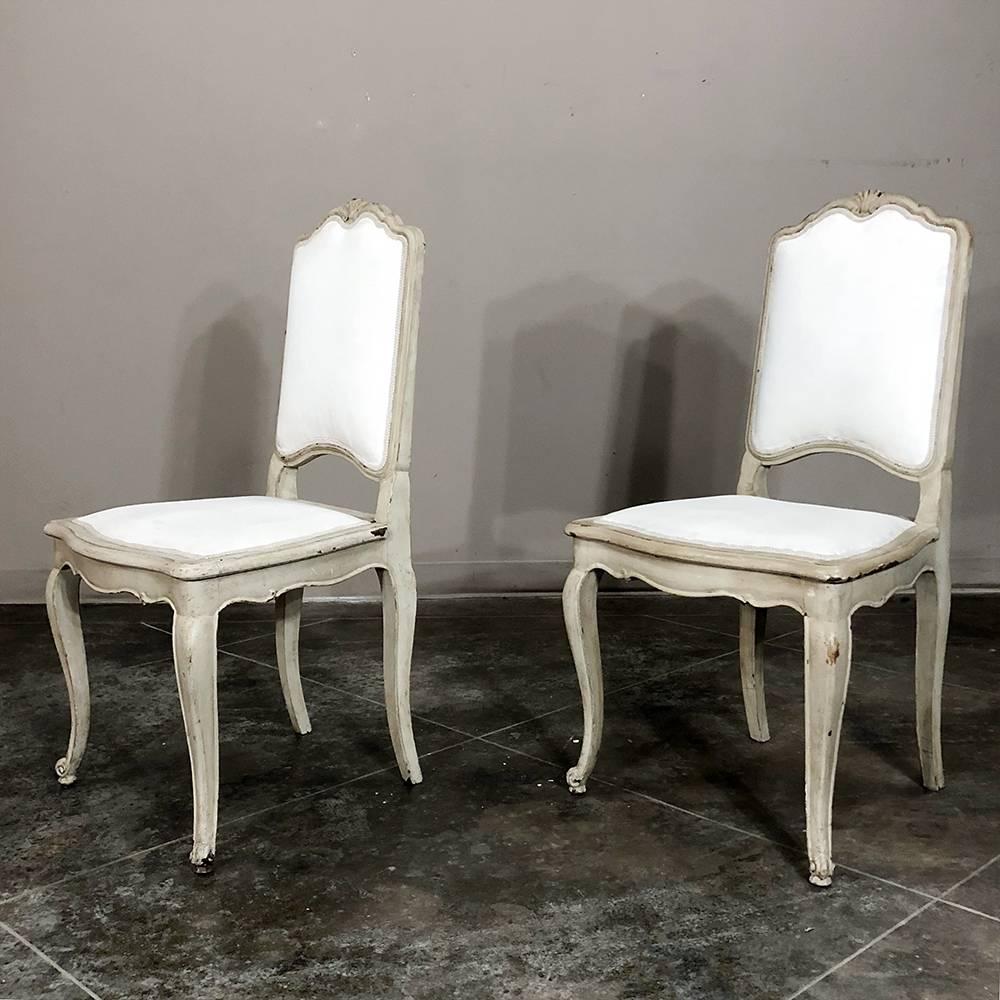 Set of six antique French Louis XV hand-painted grey dining chairs are definitive of the style, with curvaceous frames adorned with hand-carved shell and escargot accents. This set of dining chairs is sturdy, chic, and ready to be used in today's