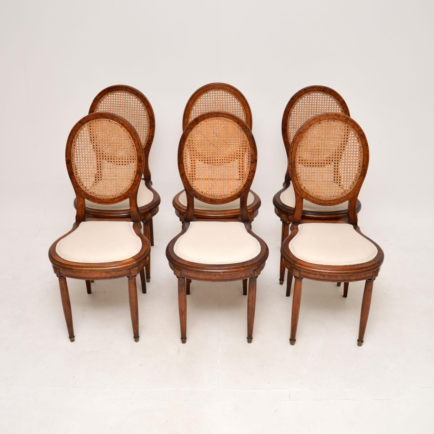 A stunning set of six antique French walnut cane back dining chairs. They were made in France, they date from around the 1890-1900 period.

The quality is superb, the oval shaped backs have lovely cane work. The chairs are solid walnut, with