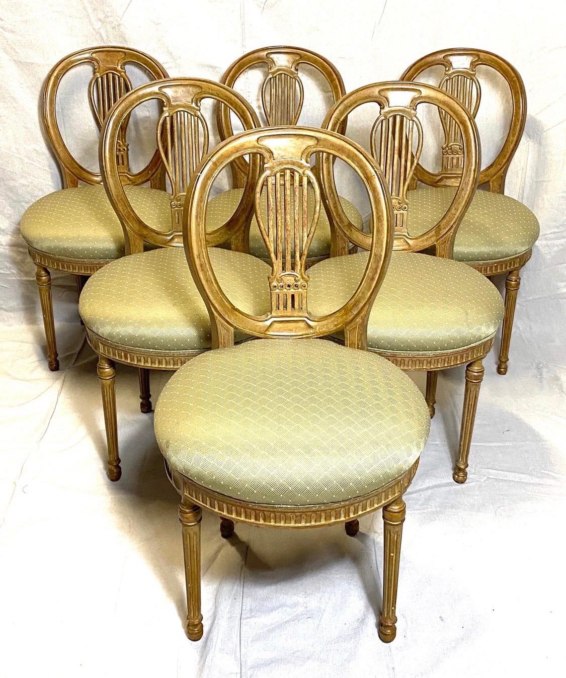 Coveted giltwood balloon back Louis XVI dining chairs with silk seat cushions. Great condition, structurally sound and lines to die for. Some minor stains on the seat cushions. Now, more than ever, home is where the heart is.