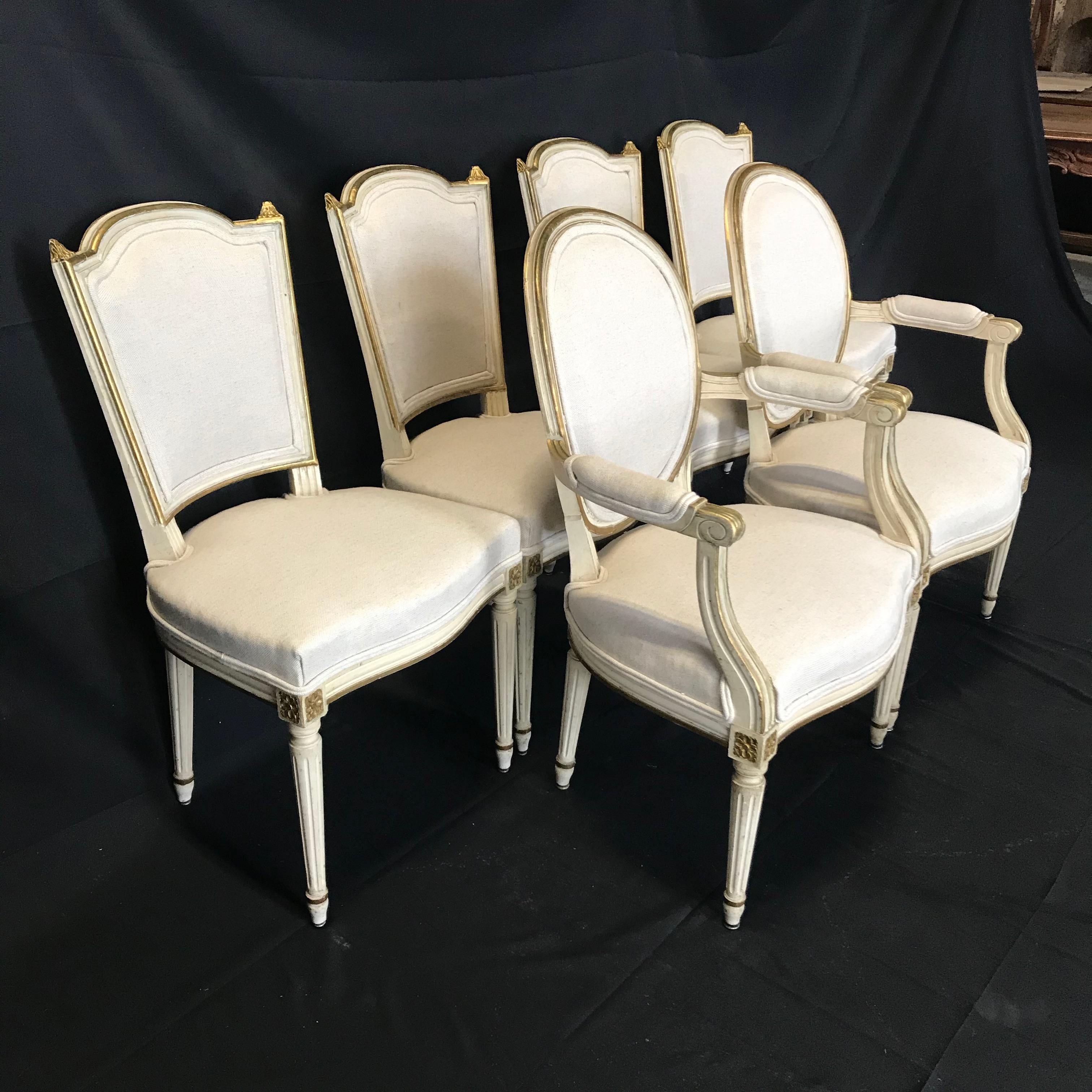 Elegant highly decorative set of 6 antique French Louis XVI dining chairs that date to the 19th century. The Classic form of the chairs combined with the beautiful natural patina of both the painted surfaces and the newly upholstered fabric make