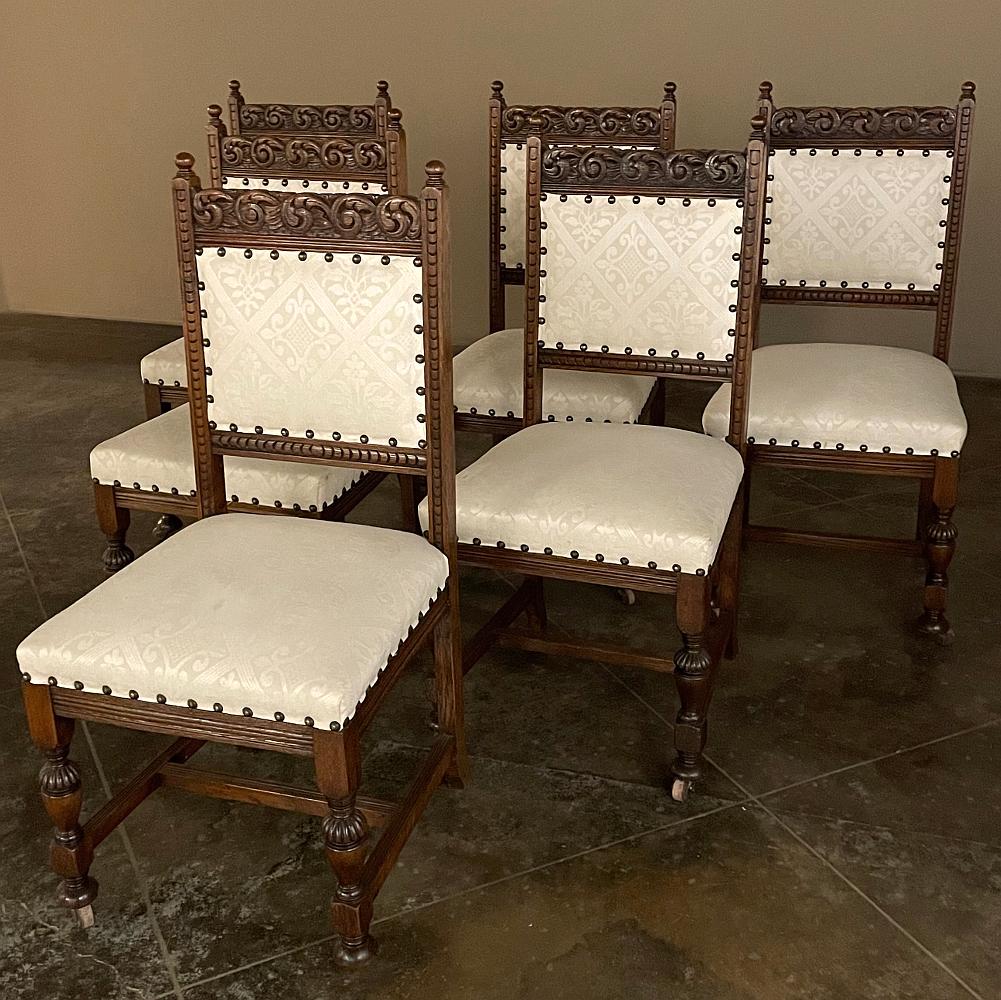 Set of six Antique Renaissance dining chairs feature classic architecture and inspired carved detail for a wonderful Old World look. The straight lines of the frameworks are accented by Greek coin overlay molding, acanthus scrolls across the top,