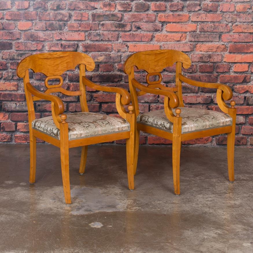The appeal of this set of six Biedermeier chairs is in the craftsmanship and Swedish design of the period. Comprised of 2 armchairs and 4 side chairs, the yellow birch glows, enhanced by the flame birch backs adding class and sophistication. All the