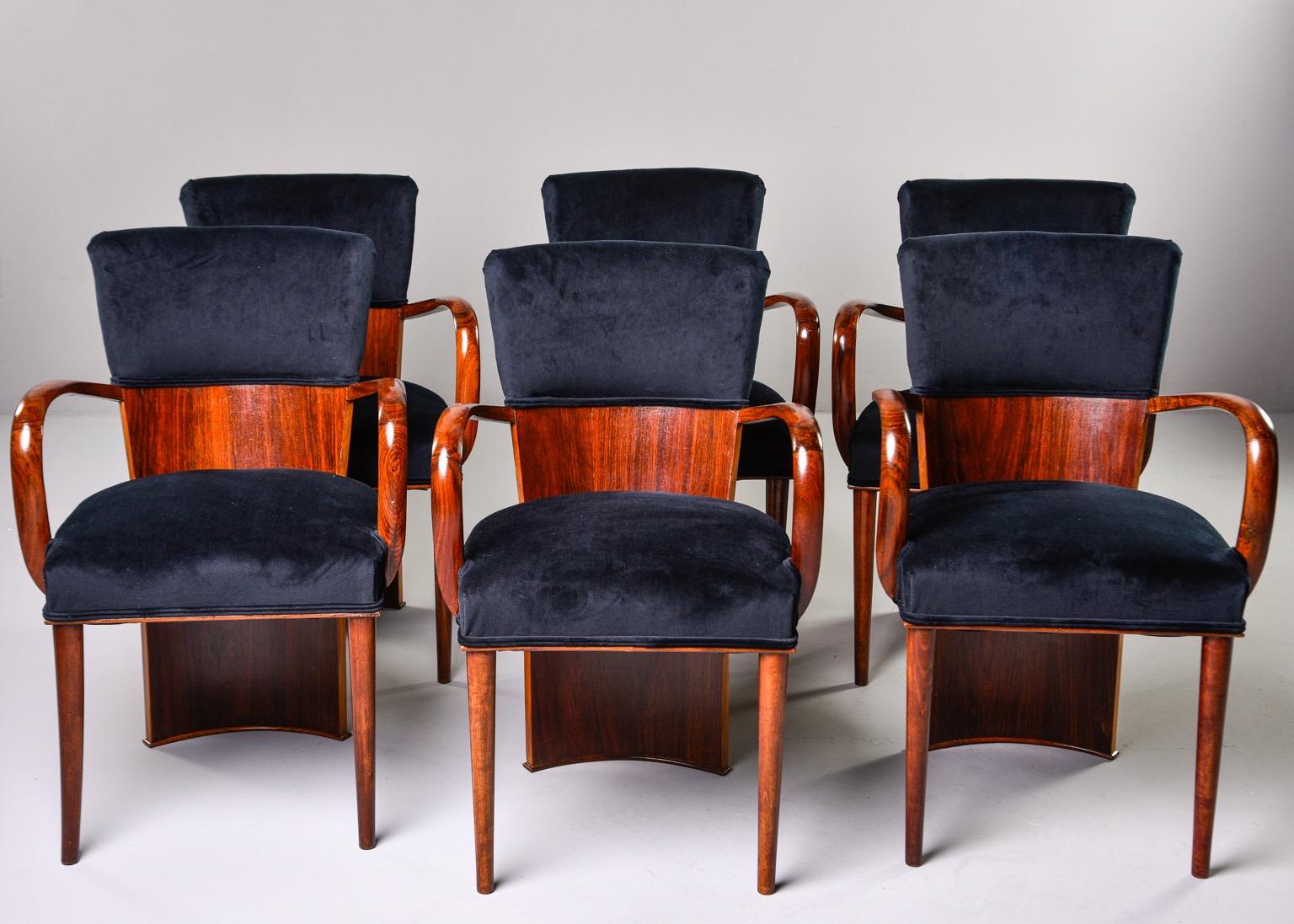 Set of six circa 1930s Italian Art Deco chairs with dramatic amboyna wood backs that extend to the floor. Chairs have tapered legs, curved armrests and padded seats and back rests that are newly upholstered in a short napped black cotton velvet.
