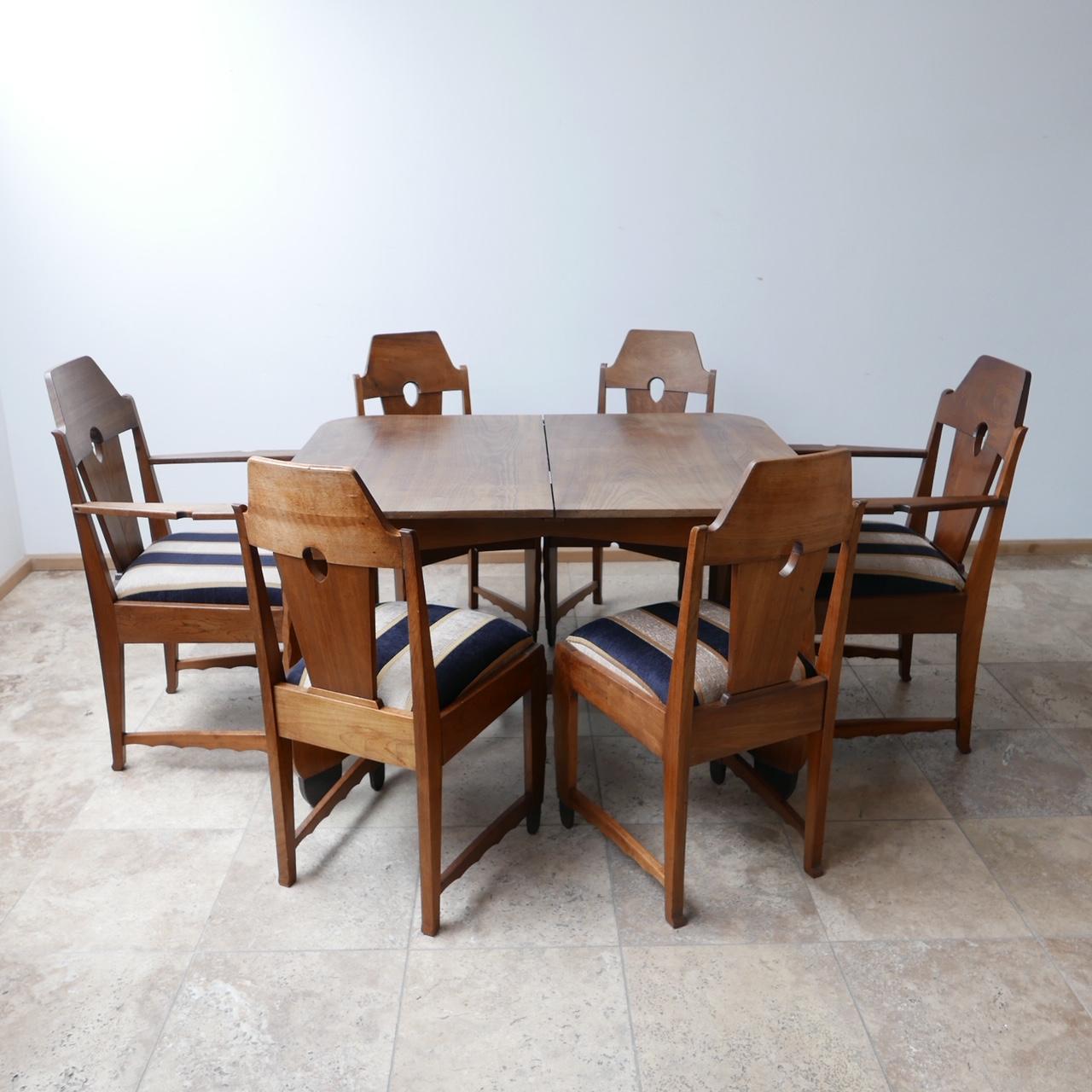 A set of six dining chairs. 

Art deco in the Amsterdam School style,

Holland, c1930s. 

Solid wood, believed to be oak, with stained feet typical of the style. 

Four normal dining chairs with two generous end chairs. 

Generally very