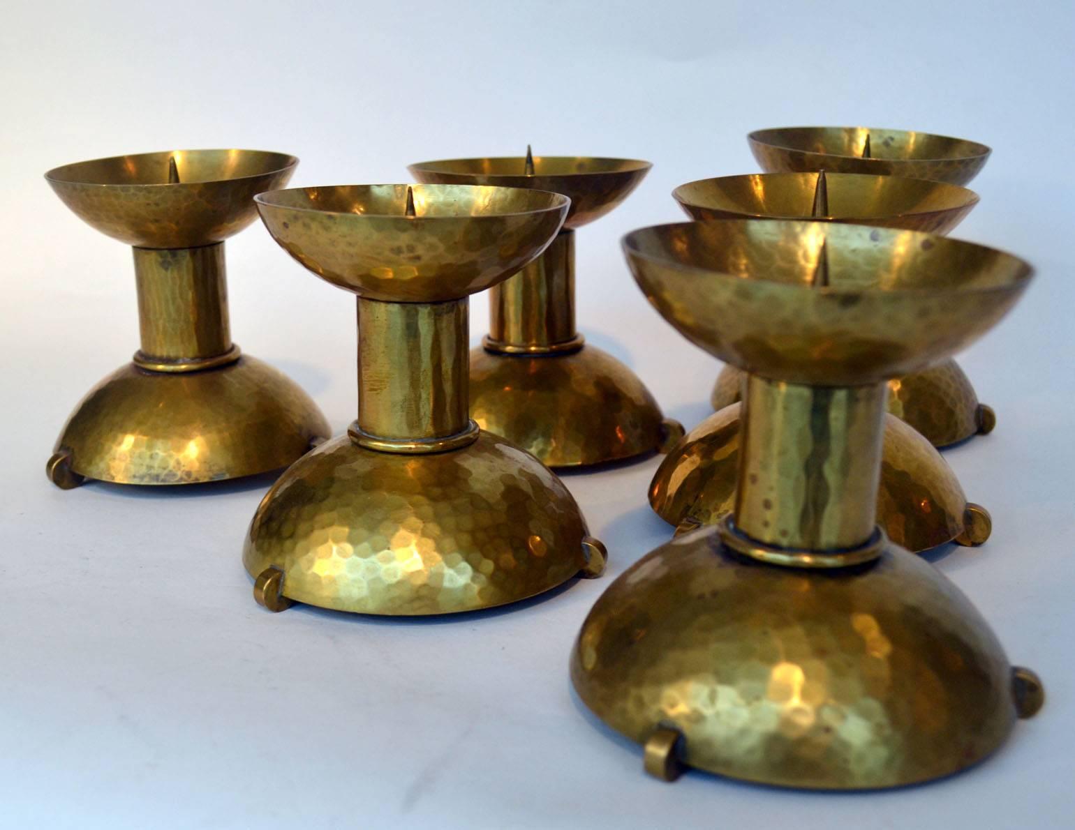 Set of six candle holders hand driven in brass for four candles, 3-6 cm wide.
Germany 1930s Bauhaus style Germany.
 