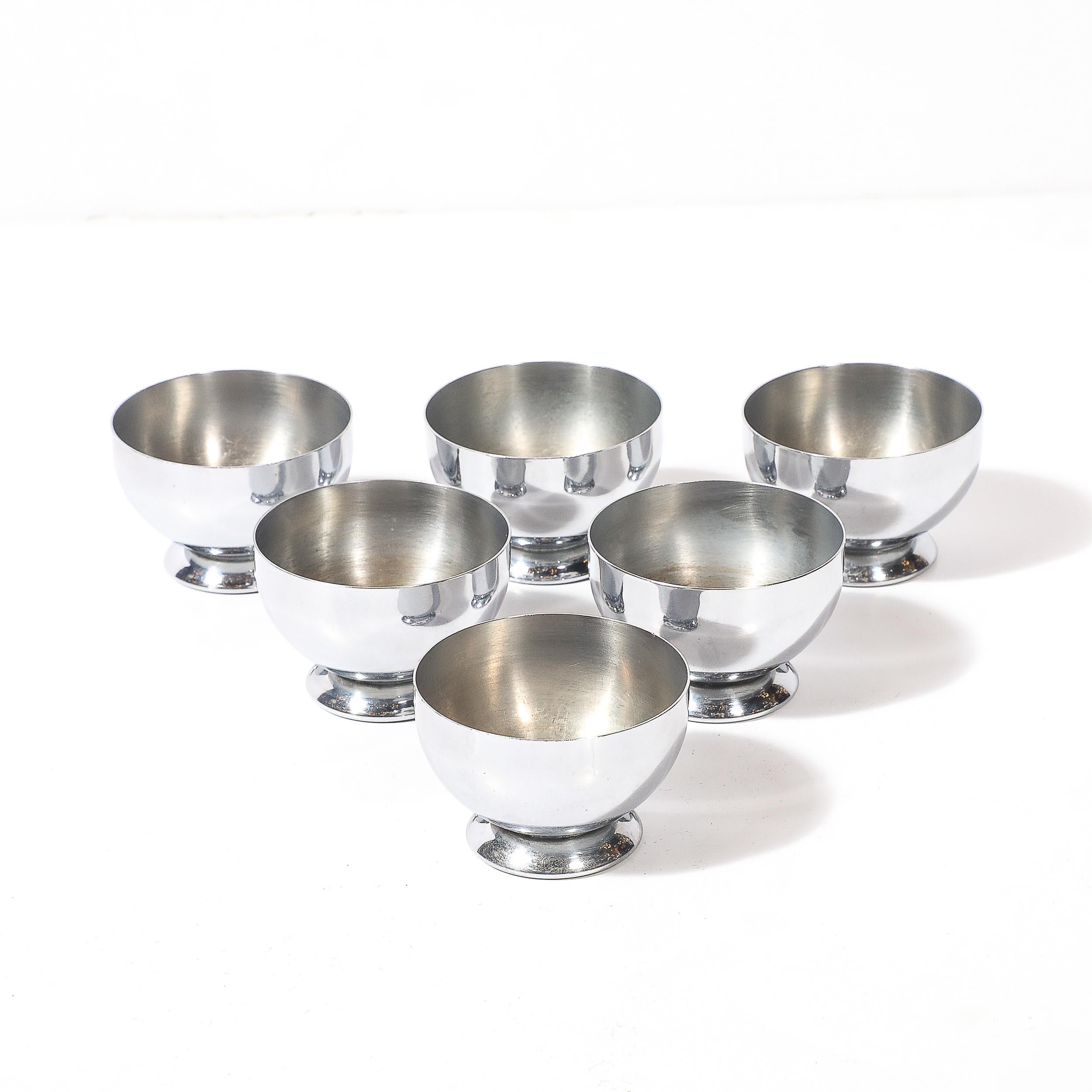 This sophisticated set of six Art Deco chrome cordials, created by Chase in America circa 1935, embodies the streamlined elegance and bold industrial craftsmanship of the Machine Age. Known for their refined designs that echo the technological