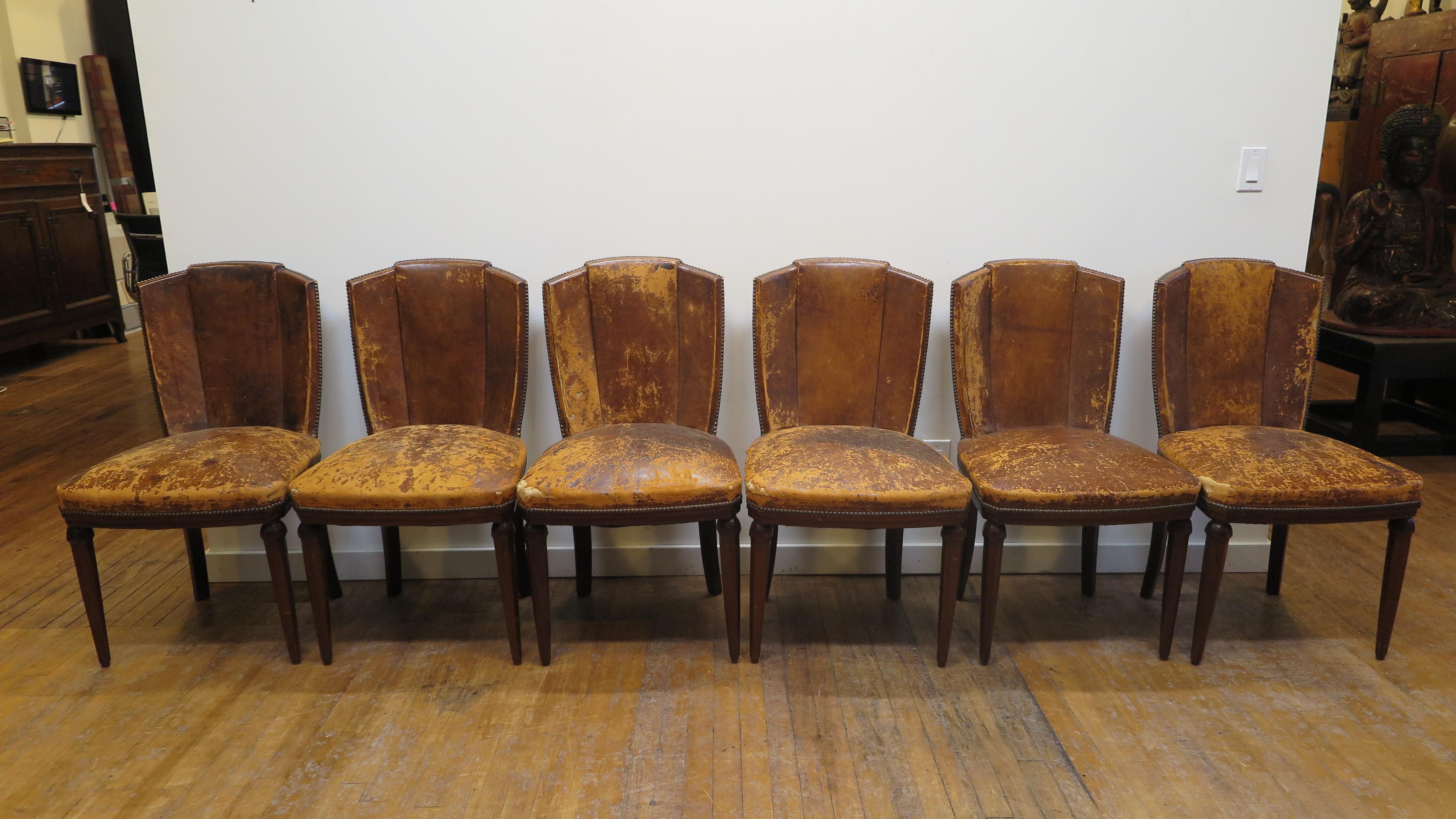 Set of six Art Deco Dining chairs with fan backs. This set needs to be recovered. The Mahogany frames are in very good condition, solid and strong. The leather is deteriorating and needs recovering. Fan Back Style is very comfortable and elegant.