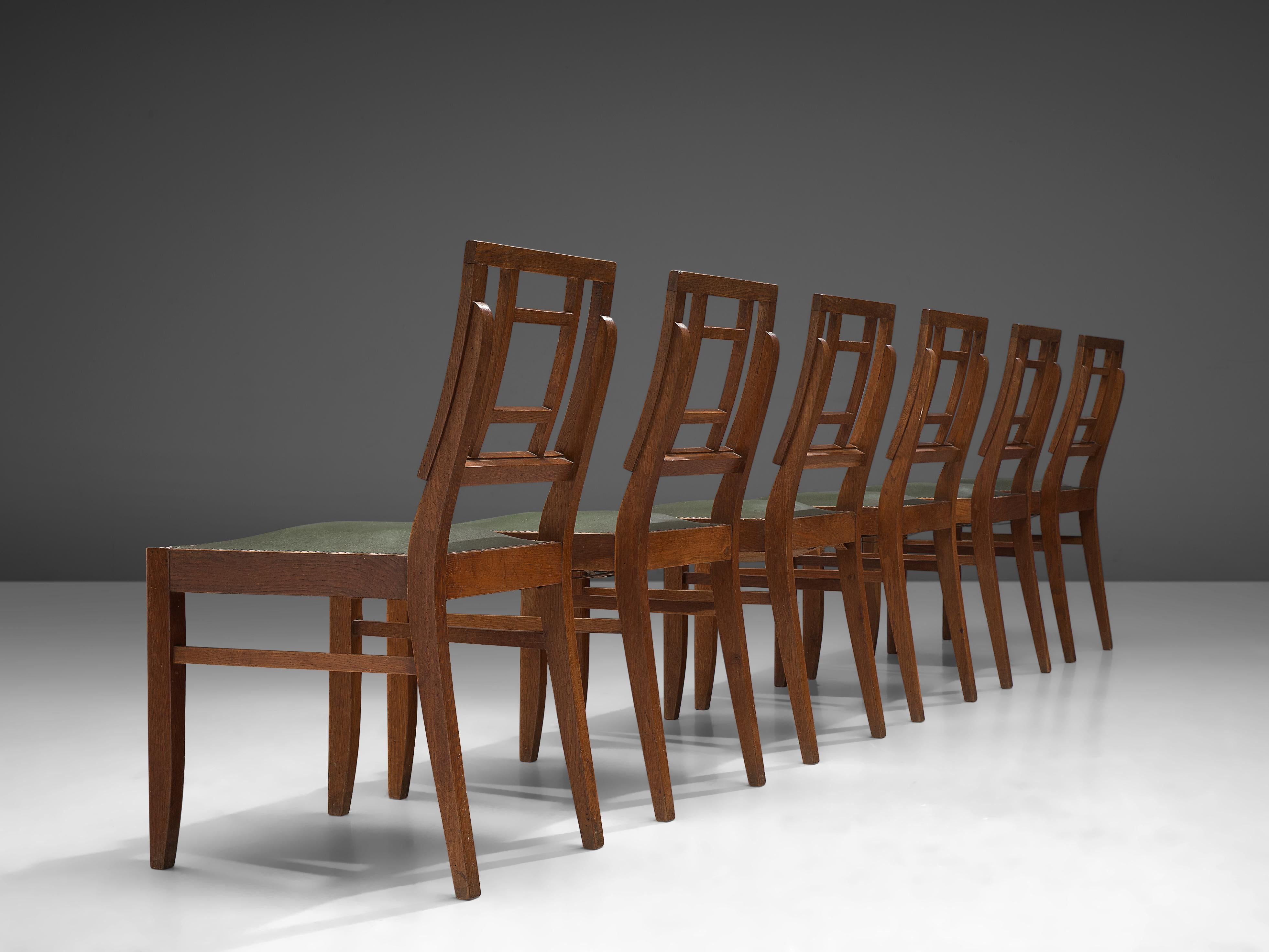 Set of six dining chairs, oak, metal, faux leather, France, 1940s

This set of French dining chairs show a basic design, with strong proportions. The geometric backrest is a typical feature from the Art Deco, which also gives the chair an open