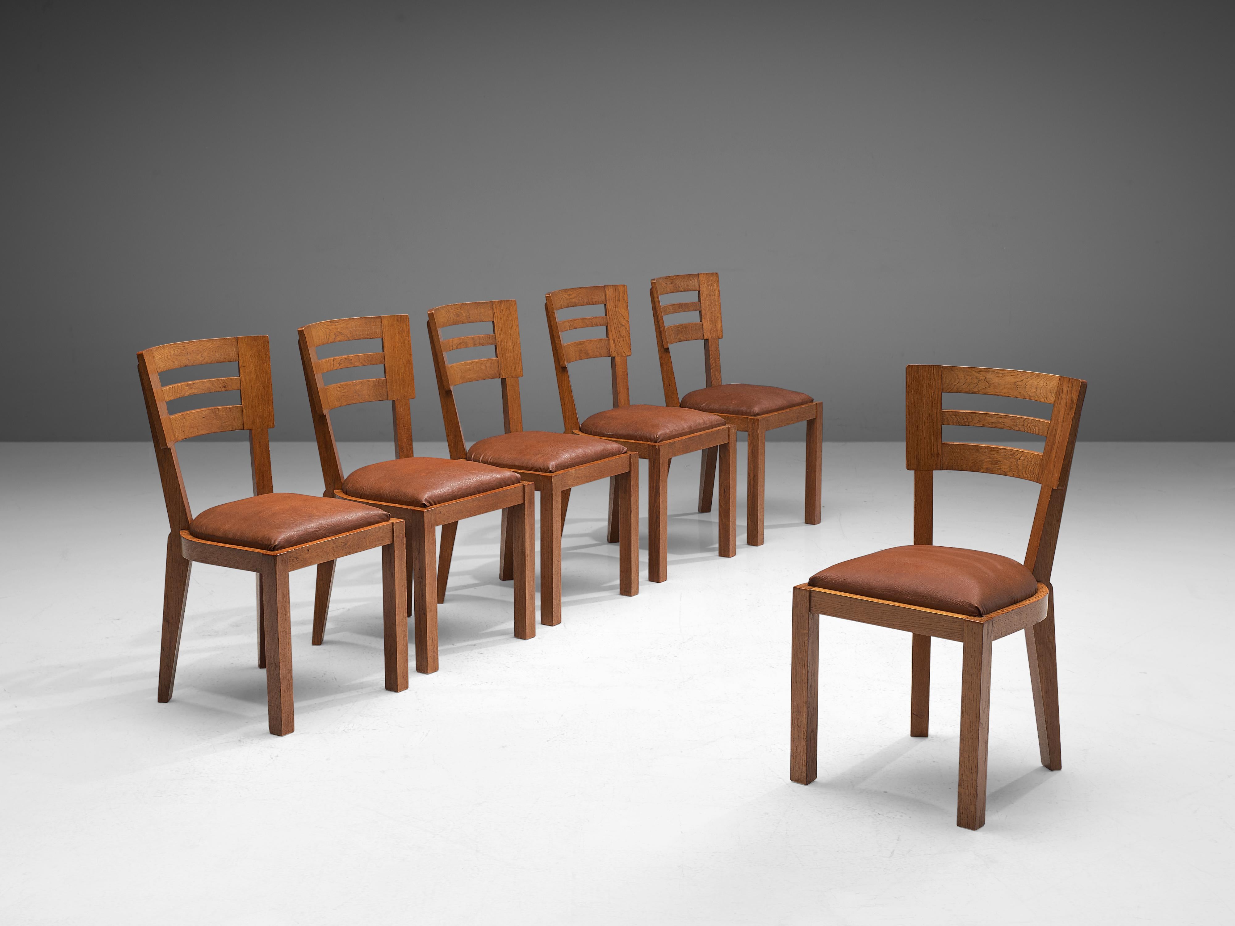 Set of six dining chairs, oak, leather, France, 1940s

Set of six French dining chairs made in the Art Deco period. A characteristic design; simplistic yet very strong in lines and proportions. The backrest embodies a slightly curved shape with two
