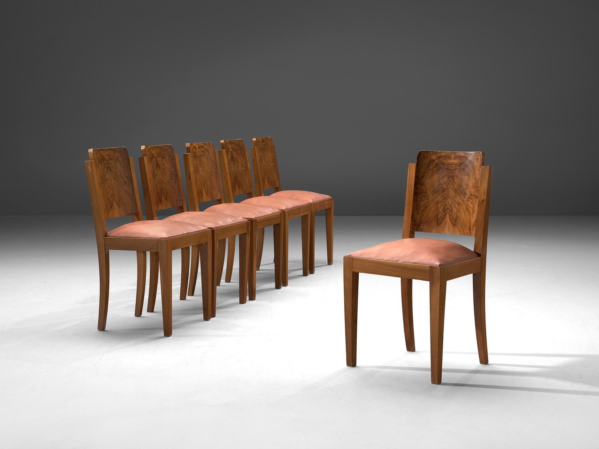 Set of 6 dining chairs, leather and walnut, Italy, 1930s

This set of six Art Deco dining chairs is upholstered in soft pink leather. The frame is made of solid walnut and features a sturdy, masculine design. The legs are rectangular and straight.