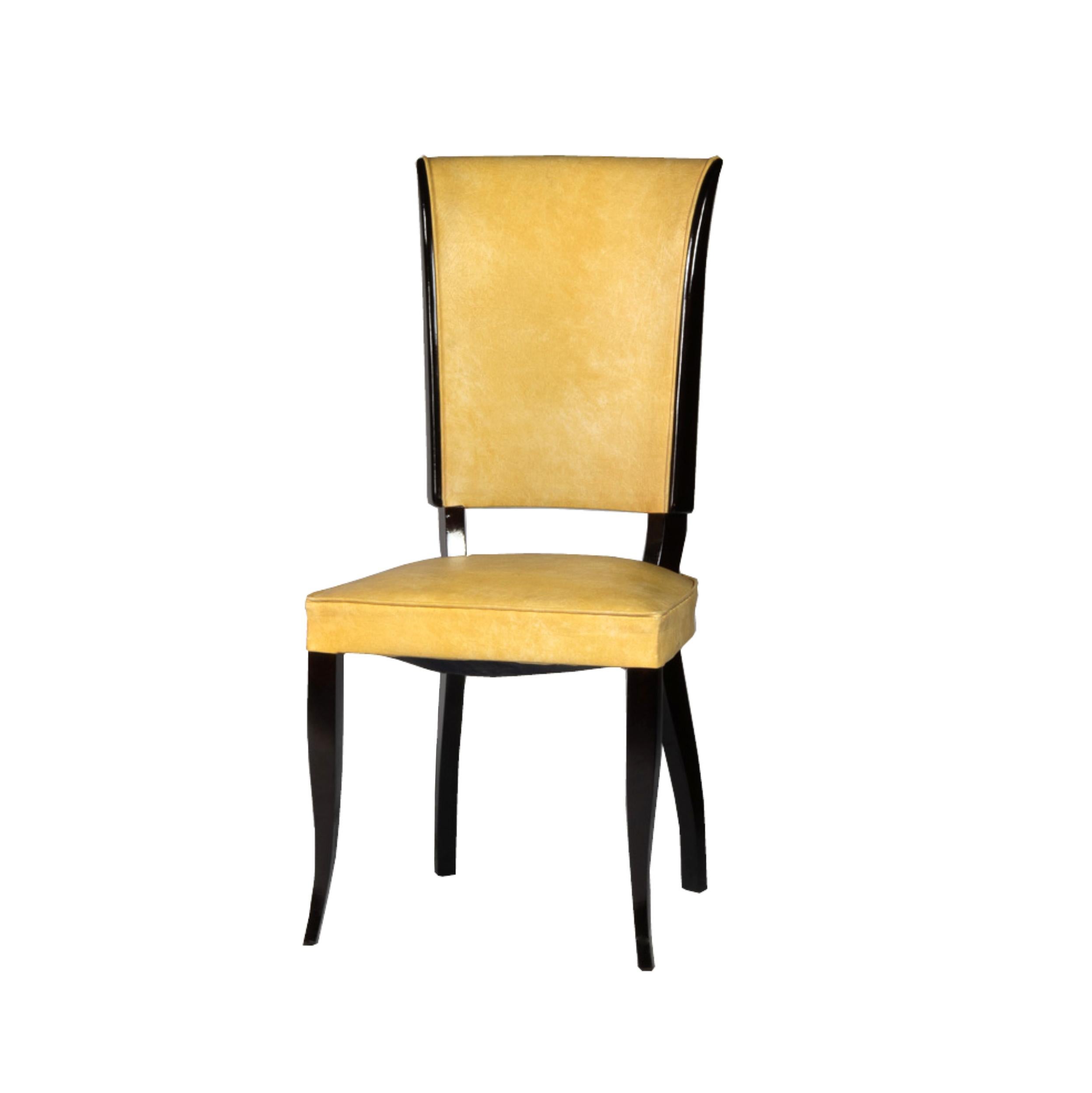 This set of six Art Deco dining chairs features a design inspired by Jules Leleu. 
The chairs have a lacquered doucine base and are upholstered in yellow vinyl. 

Take into account that the colors on the items may vary depending on the type of
