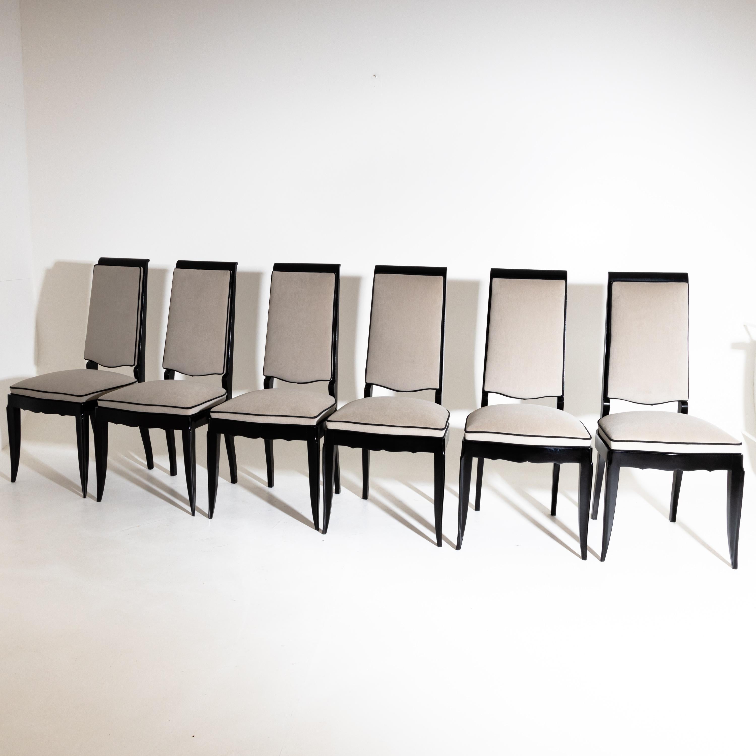 Set of six ebonized dining room chairs with curved frames and upholstered seats and backs. The chairs have been reupholstered in a grey velvet fabric with black piping and the frame hand polished.
   
