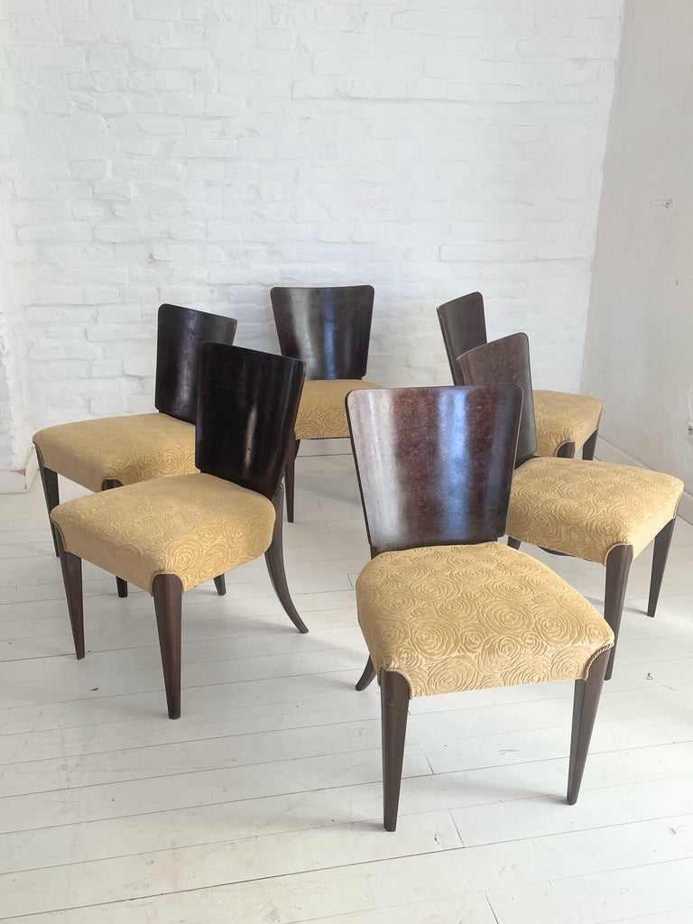These Art Deco chairs, model H - 214, were designed by Jindrich Halabala and manufactured by Up Zavody in Czechoslovakia. The set features a walnut veneer with newly upholstered seats. The wood has been refreshed and the shape has been kept in every