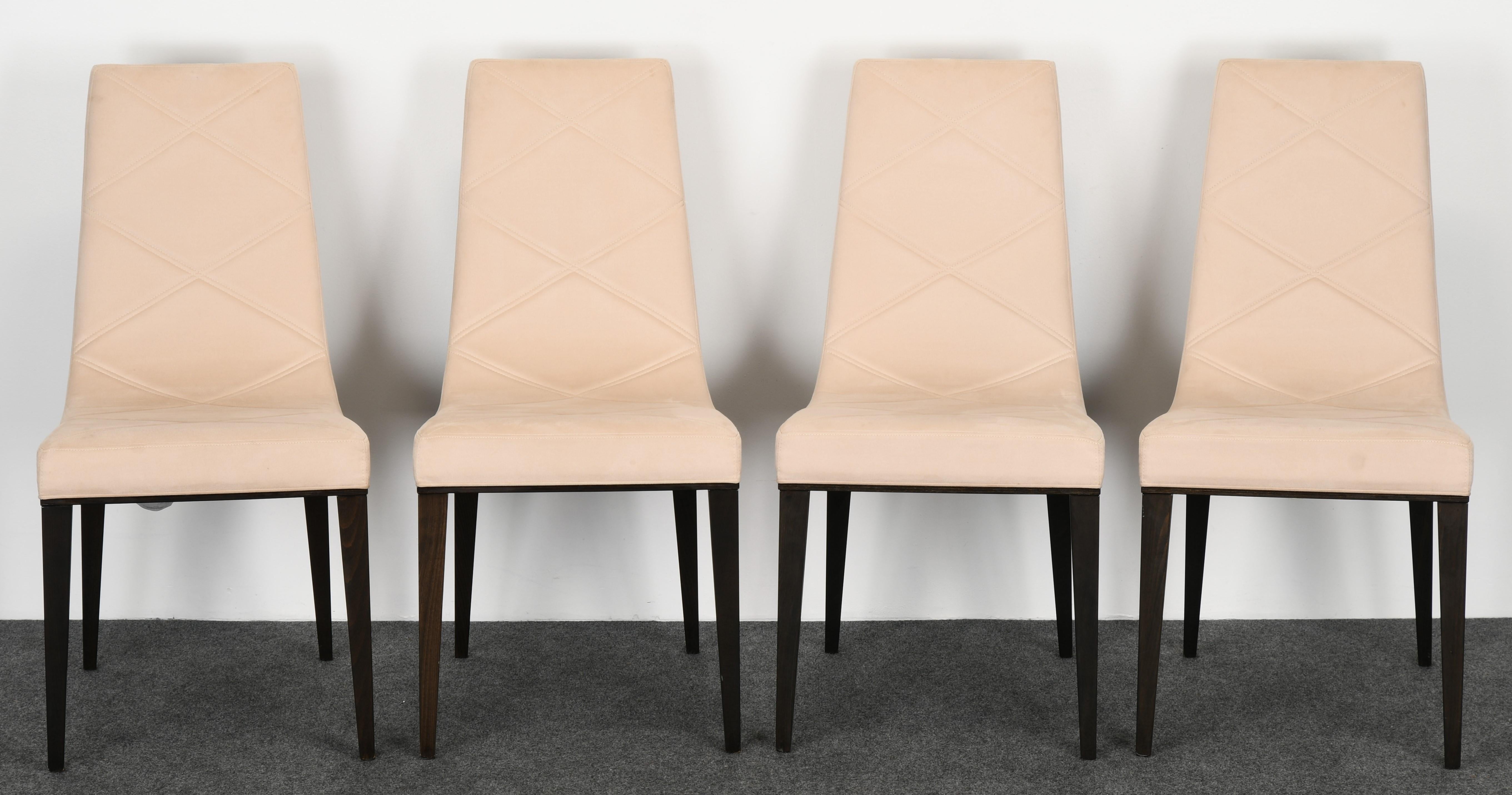 A very sleek Modern set of six Art Deco style dining chairs by Pietro Costantini, 1980s. The chairs are upholstered in quilted ultra-suede fabric with chocolate ebonized finish. This set includes two armchairs and four side chairs. The chairs are in