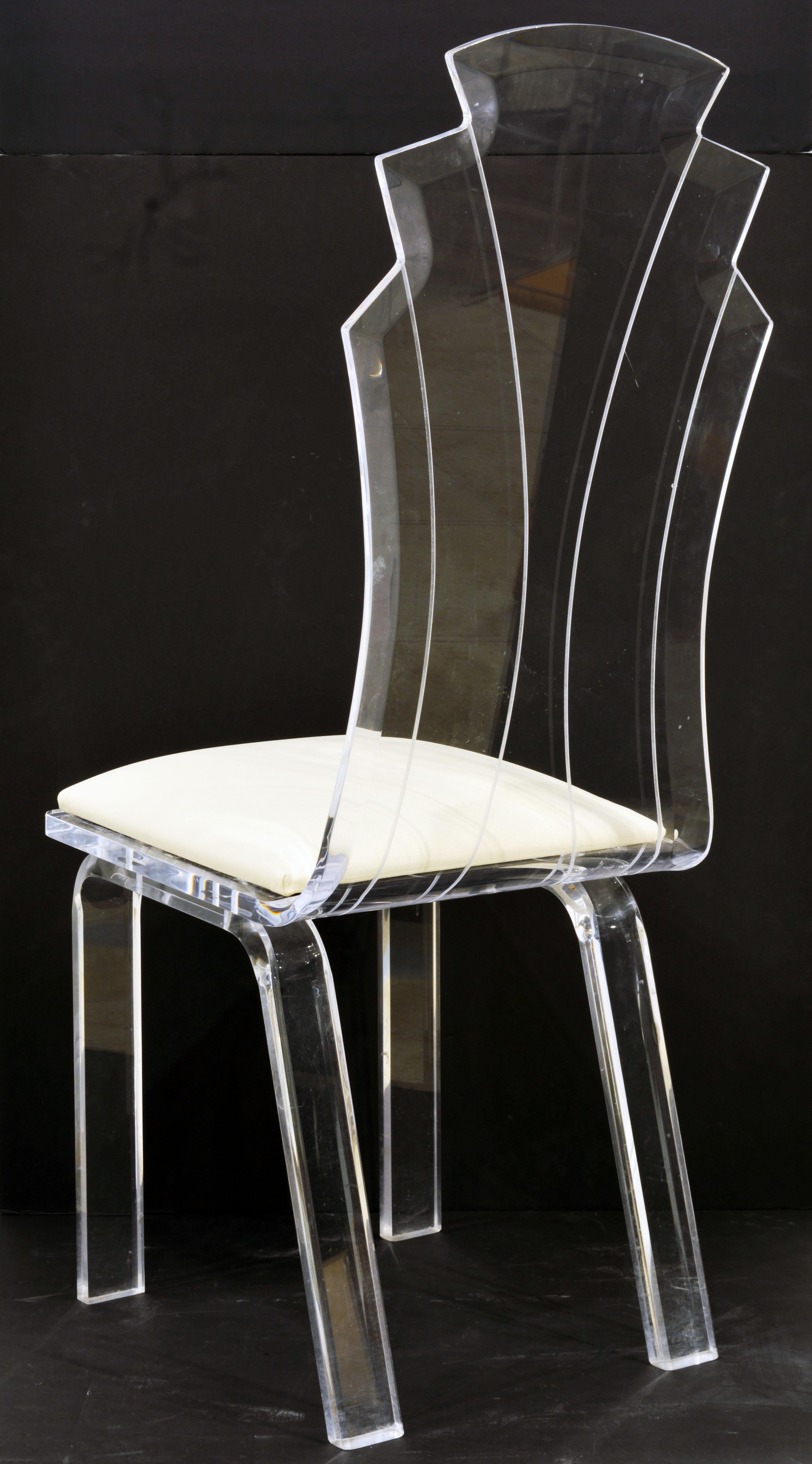 A set of 6 rare art deco style Lucite dining chairs of excellent construction and beautifully shaped and crafted fan form backrests with etched pattern lines. The chairs come with newly made loose off white vinyl covered cushion seats, that can be