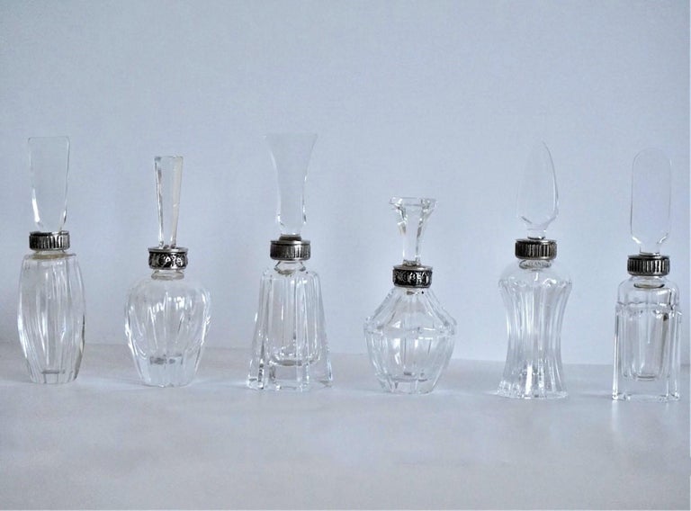 A wonderful set of six cut crystal and silver perfume bottles with crystal rod stopper, 