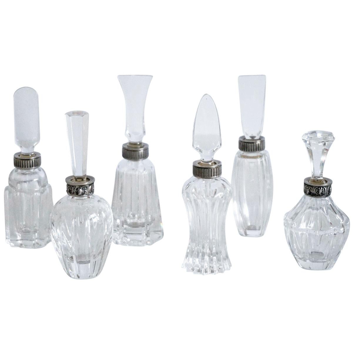 A wonderful cut crystal and silver set of six perfume bottles with crystal rod stopper, 