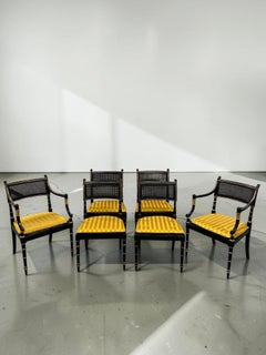 Set of Six Baker Furniture Regency Ebonized and Parcel Gilt Cane Dining Chairs