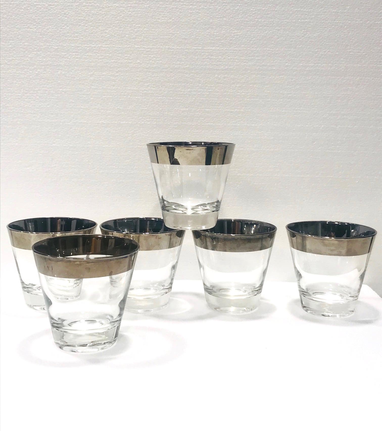 Iconic Mid-Century Modern cocktail glasses by Dorothy Thorpe. Set includes six rock glasses with tapered design and with silver overlay rim. Makes a chic and timeless addition to any bar set. Washing by hand is best in order to preserve the silver