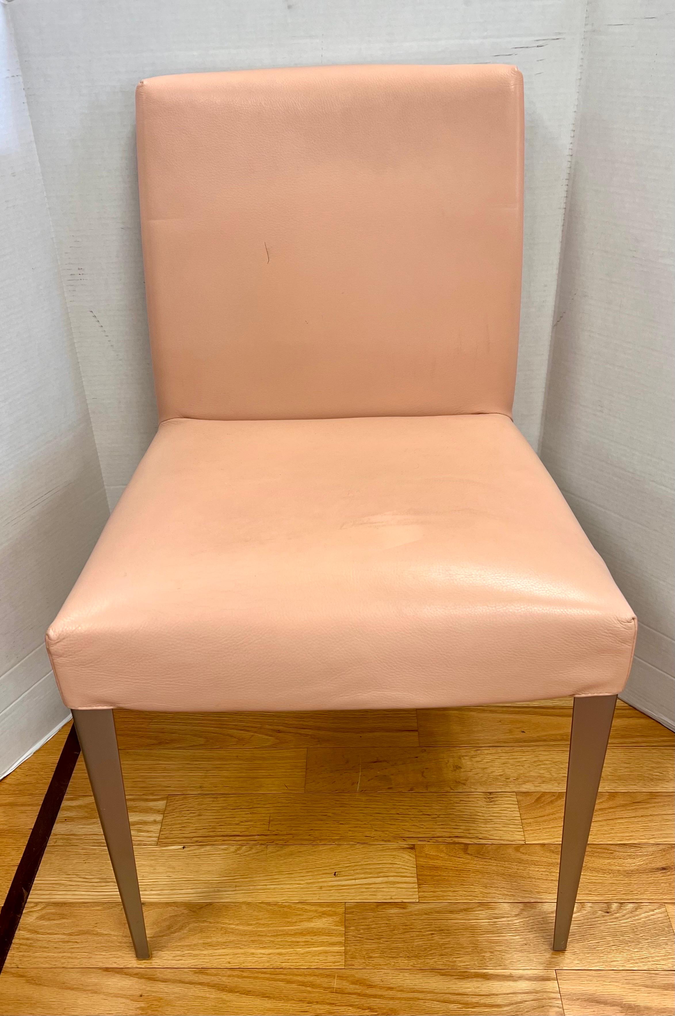 Gorgeous set of six B&B Italia Melandra dining chairs by Antonio Citterio. The chairs are in a pink leather and supported on grey steel legs. Each with the B&B Italia insignia stamped on the back.