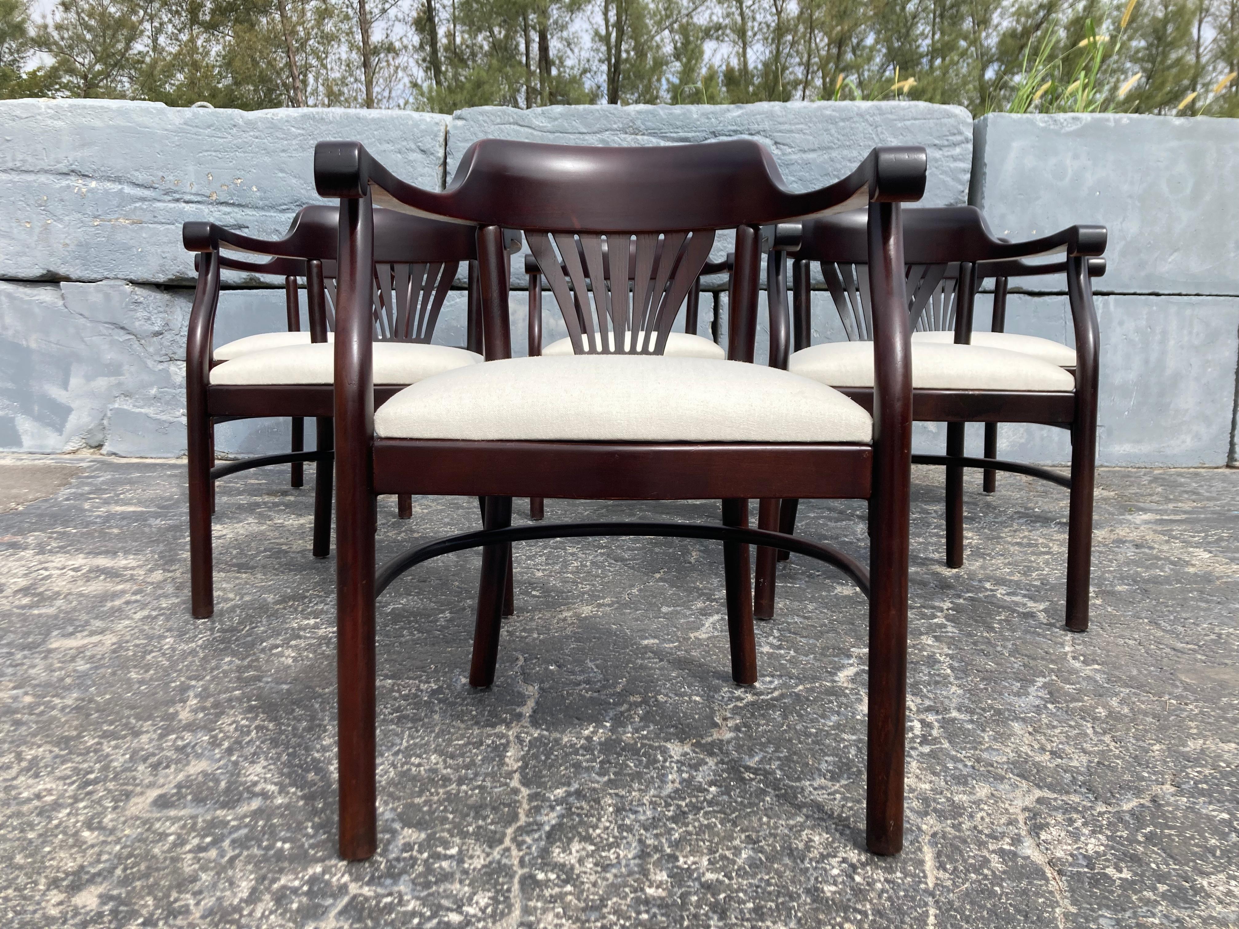 Set of Six Bentwood Arm Dining Chairs In the style of Thonet. Seats have been recently reupholstered, wood has a dark mahogany finish. Selling as a set of six, in total 12 chairs available.
Front Arm height is 27.25”