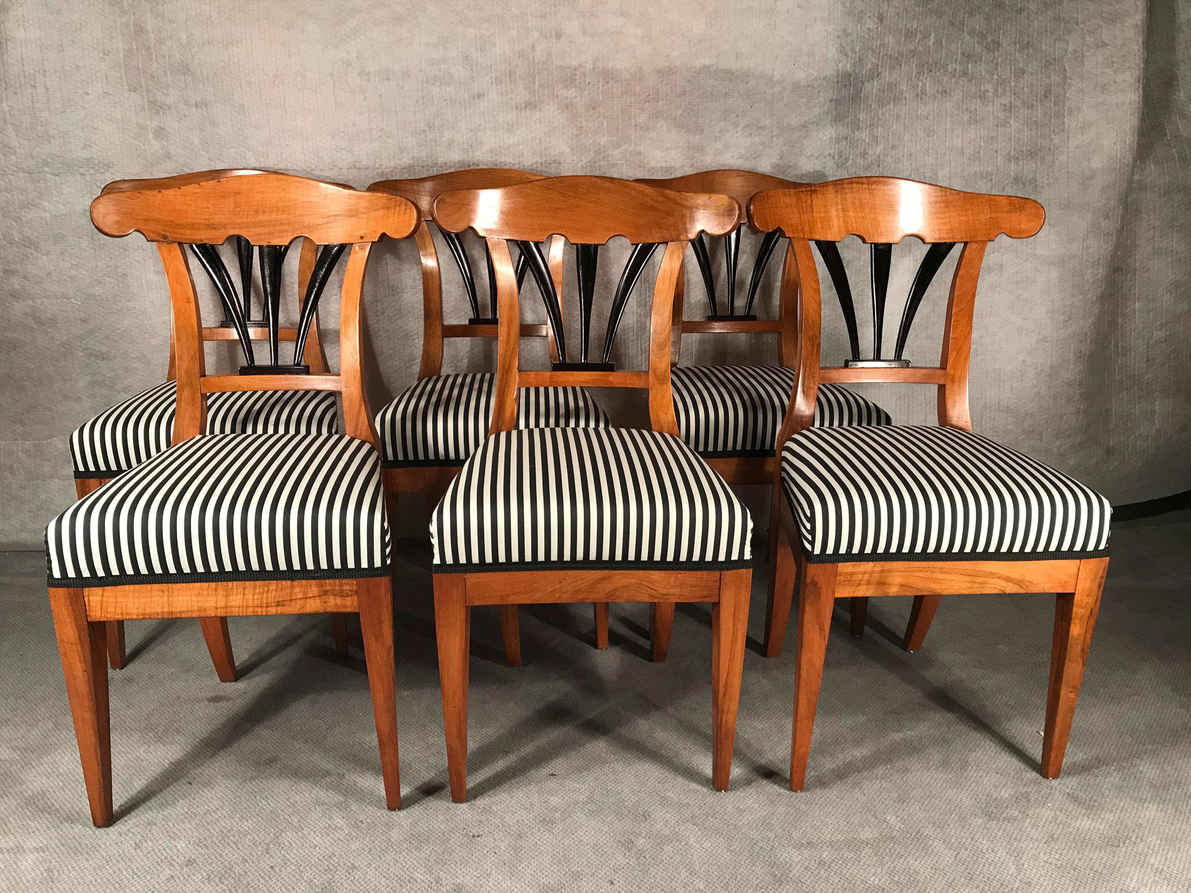 Set of six Biedermeier chairs, South German, 1825-1830, walnut veneer with ebonized details on the back. These beautiful chairs are in excellent refinished condition. They have a new upholstery and are covered with a gorgeous black and white striped