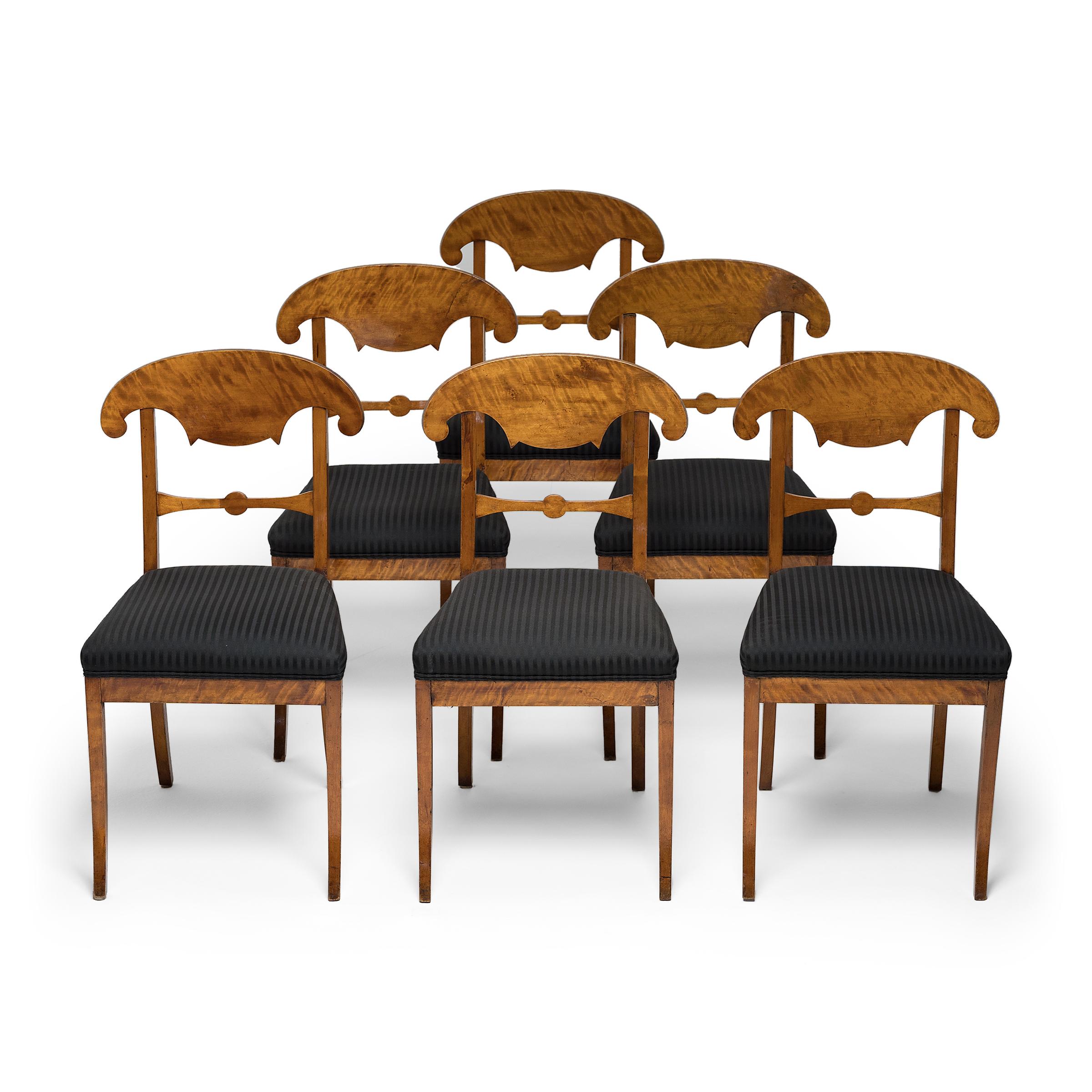 This set of six Biedermeier dining chairs is crafted with the classic lines and elegant simplicity that defined furniture of the Biedermeier period (1815-1848). Considered the first European decorative style driven by middle-class tastes, the