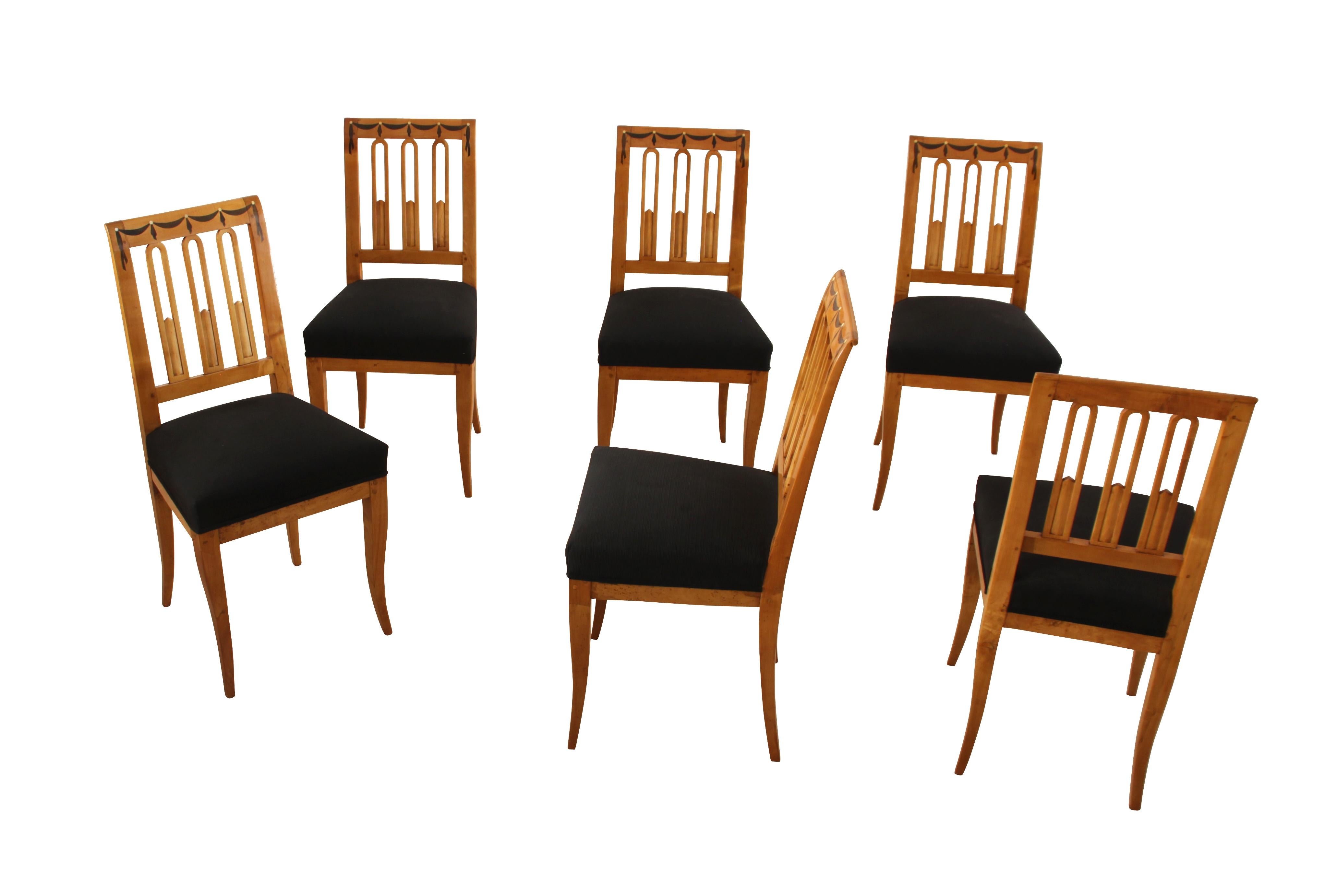 Set of six early Biedermeier chairs from South Germany about 1820.

The chairs are made from a beautiful birch solid wood. Around the top of the chairs there is are inlay marquetries made of ebony and bone, in form of a garland. Very neoclassical