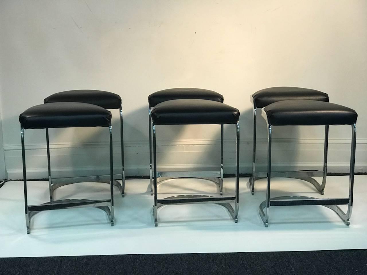Set of six black leatherette and chrome stools with demilune seat and base. Substantial curving chrome frame.
These stools were designed in the 1970s-1980s and atrributed to Milo Baughman for DIA.