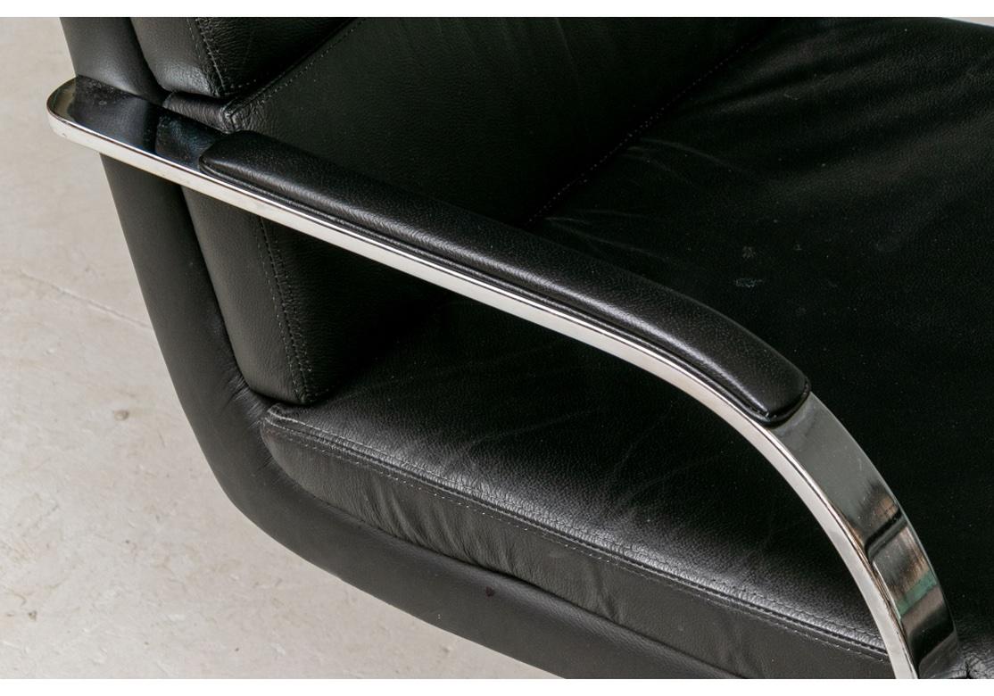 Comfortable and good looking mid-century design with curved Chrome arms, legs and flat feet in one piece. With a flat stretcher. Channel back construction on a single piece curved back and seat, with a slightly curved seat cushion. Very well made