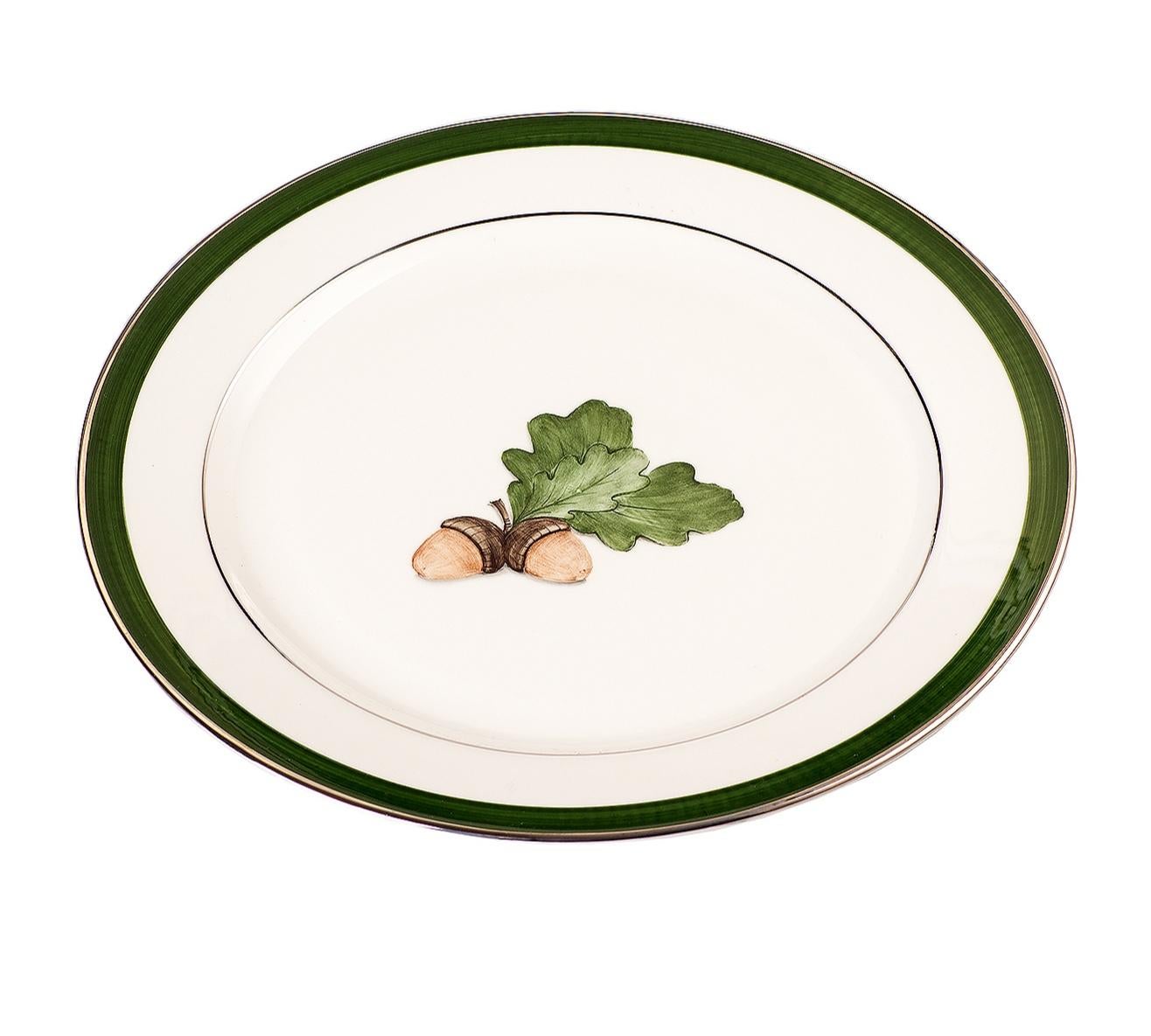 Set of six completely handmade and hand painted underglaze porzelain breakfast plates. The decor shows a Black Forest hands-free painted oak leaf with a green handsfree line and platinum rimmed. A matching dinner plate and soup plate can be ordered