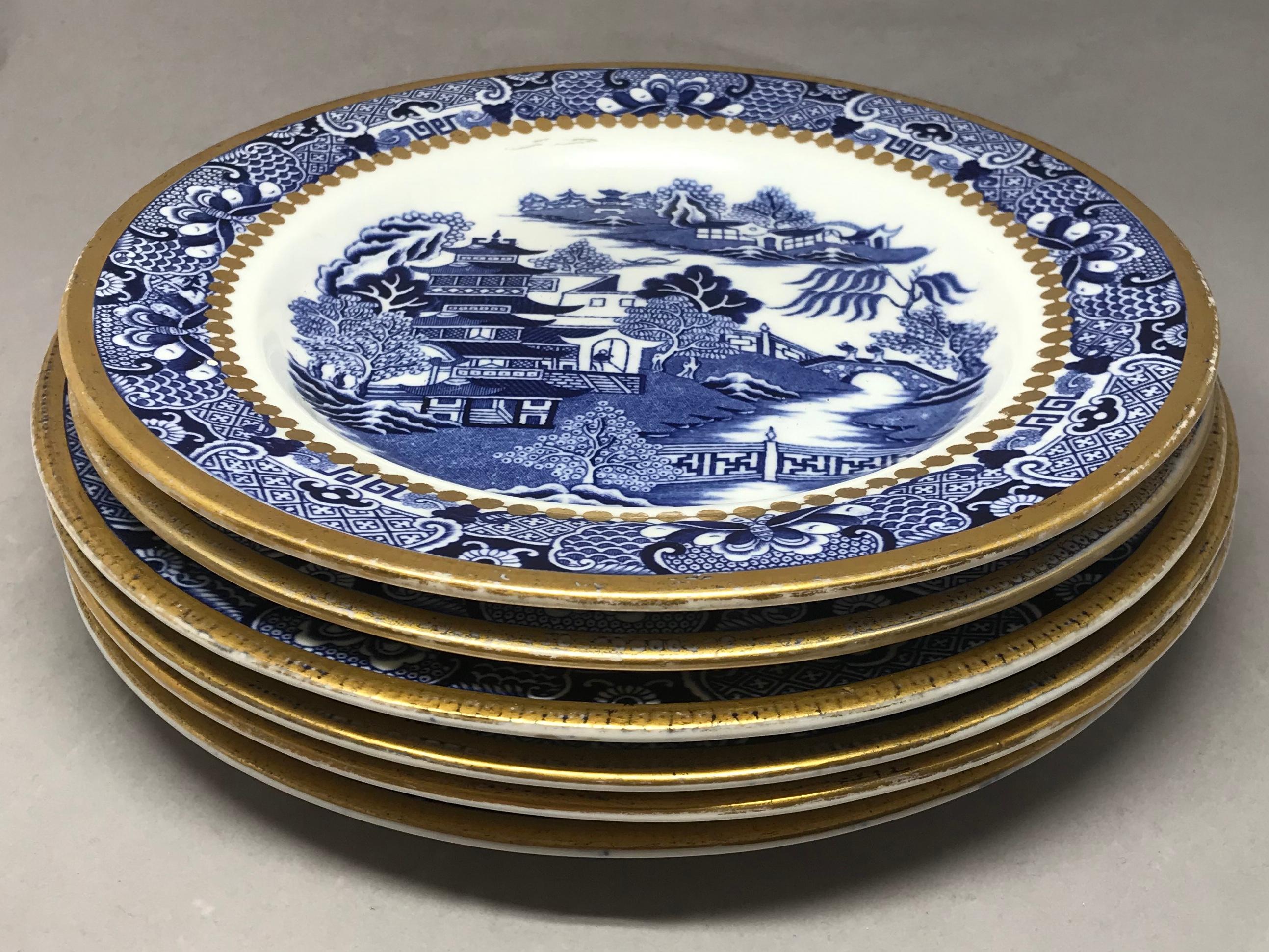 Set of six blue and white English plates. Assembled set of six blue willow and white Davenport Longport Staffordshire plates with gilt rim in the 