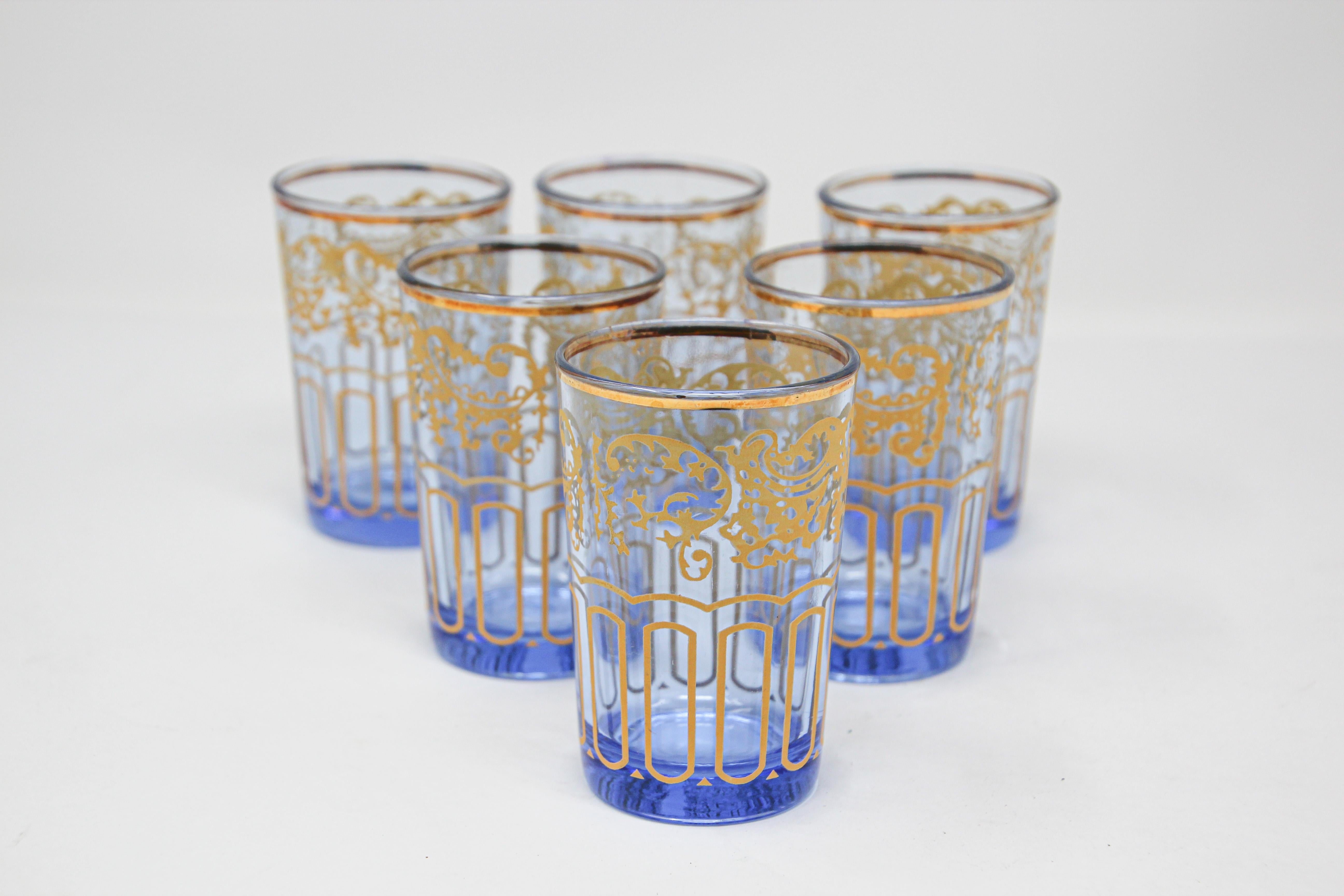 Set of six Moroccan blue glasses with gold raised Moorish design.
Decorated with a classical gold and pattern Moorish frieze. 
Use these elegant glasses for Moroccan tea, or any hot or cold drink.
In fantastic condition, perfect for the holidays and