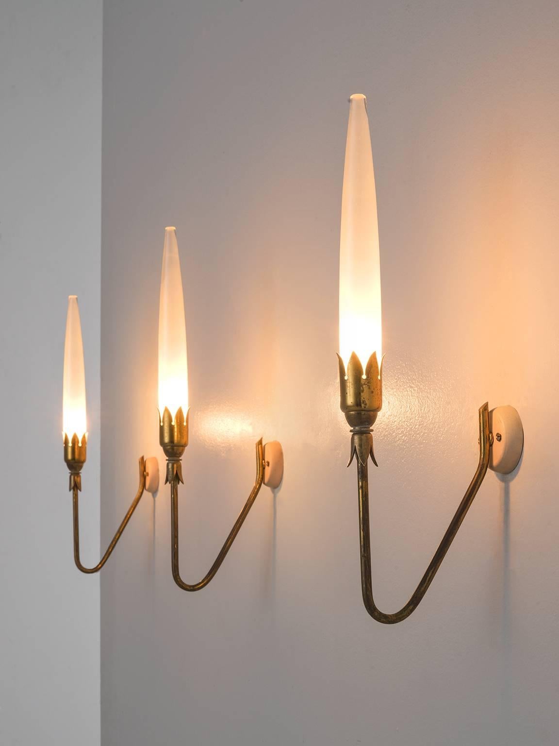 Set of six wall lights in brass and glass, Italy, 1950s.

Set of six slender wall lights are executed in brass and glass are attributed to Angelo Lelli. These sconces hold a thin organic brass frame with an admirable patina. The crown holds the
