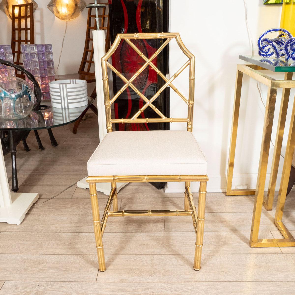 Set of six brass faux bamboo side dining chairs with upholstered seats.