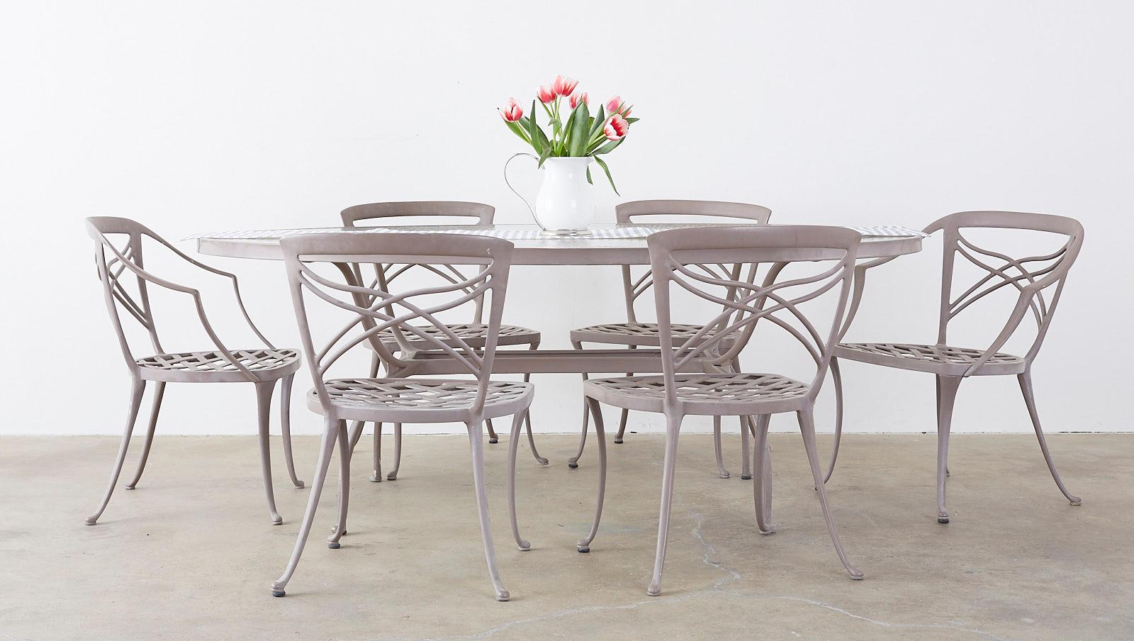 Graceful set of six patio garden dining chairs made in the neoclassical style by Brown Jordan. Features an aluminium construction with a powder-coated finish in a lovely taupe grey color. Consisting of two armchairs and four side chairs the latter