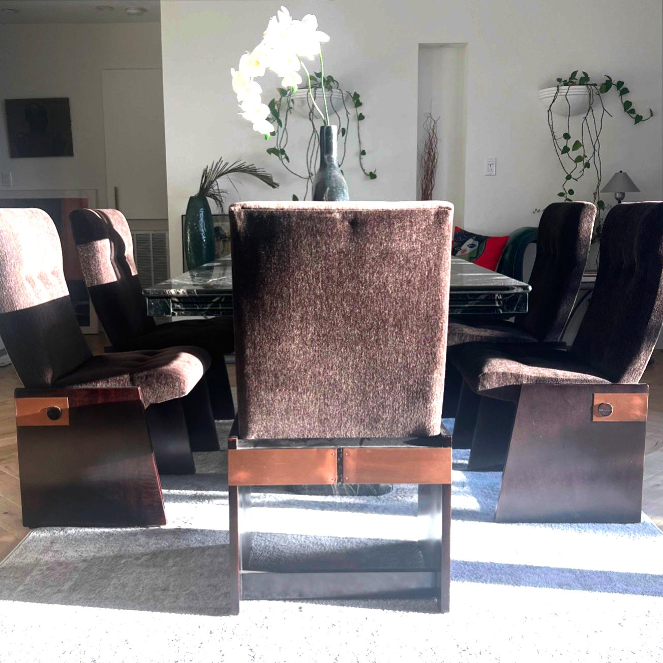 A set of six sultry brutalist dining chairs by Lane Furniture, circa mid 1970s. Featuring deep chocolate toned fabric, espresso stained wood frames, and wraparound copper hardware. These unique chairs boast stark and harsh geometry classic to