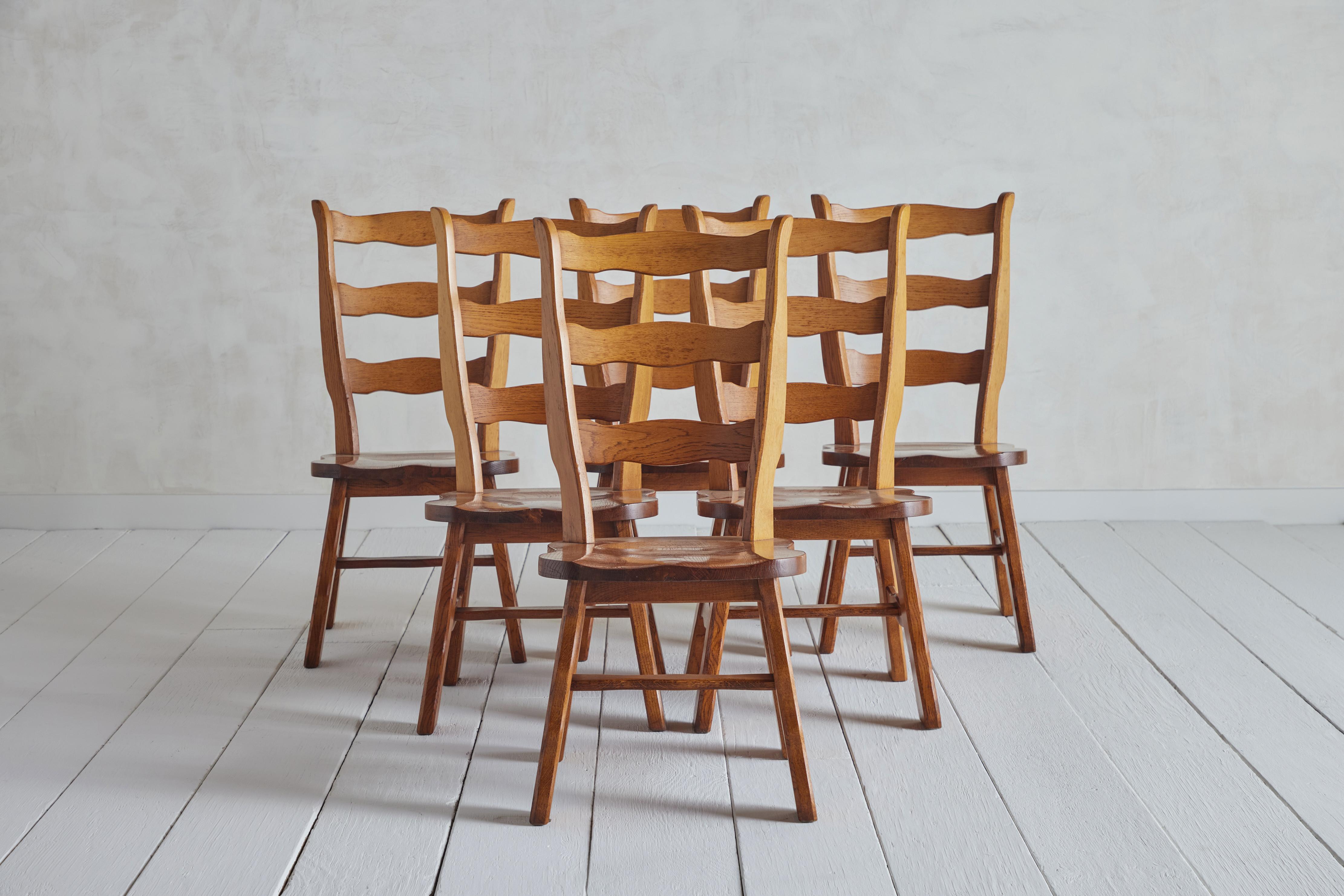 Set of six Brutalist ladderback chairs from Belgium circa 1960. Made of solid oak. Wear on wood and finish is consistent with age and use.