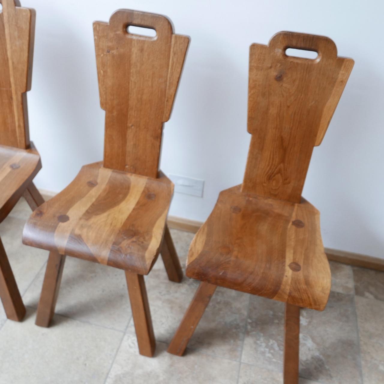 A set of mid-century brutalist dining chairs. 

Belgium, c1970s. 

Solid wood, likely oak. 

Well formed and crafted. 

Price is for the set. 

Dimensions: 38.5 W x 50 D x 45 Seat Height x 94 Total Height in cm.

Delivery: POA

Viewing