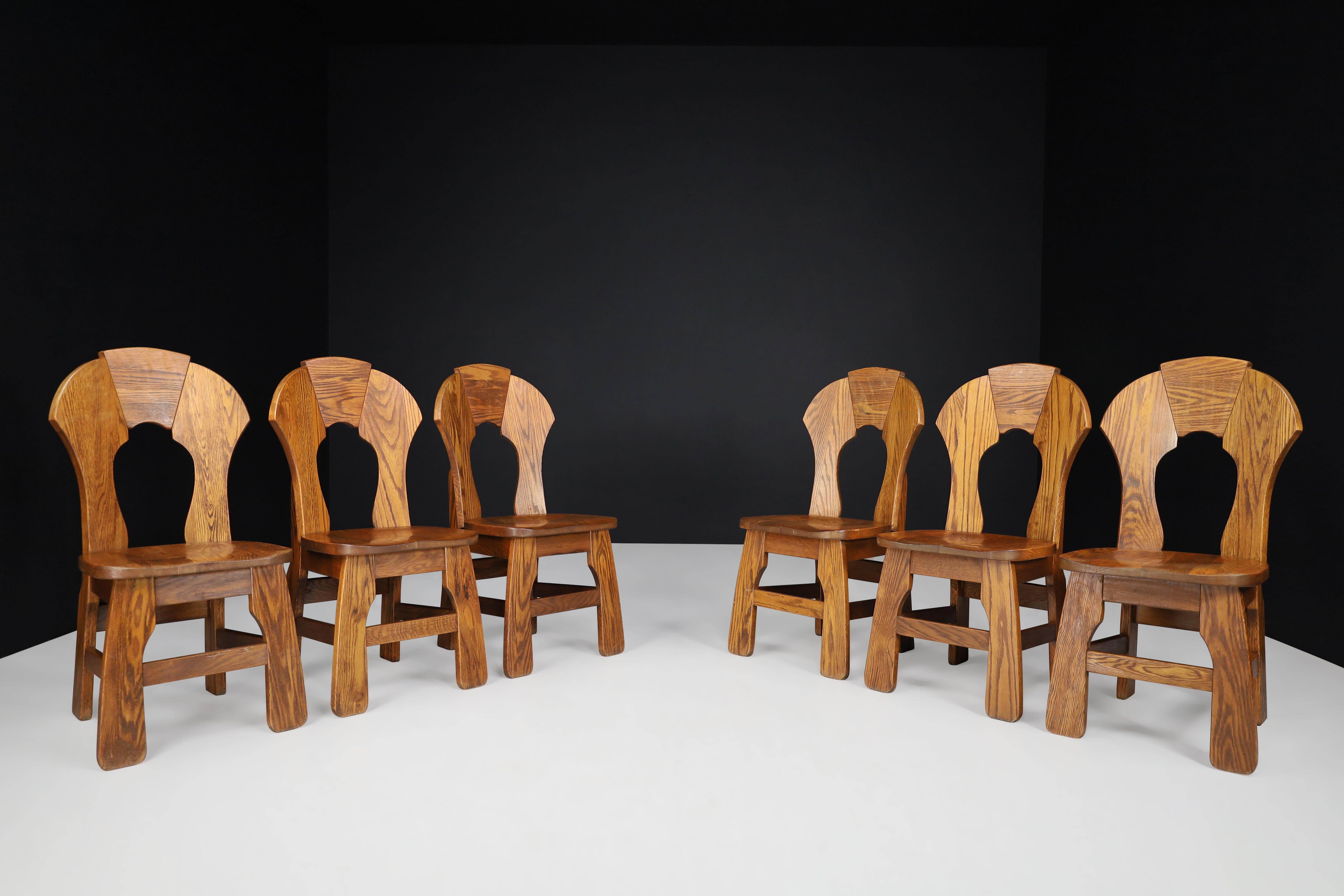 Set of Six Brutalist Oak dining chairs, France, 1960s 

Brutalist, Oak dining chairs with curved in the back, France 1960s. These chairs are made entirely of wood. They are in excellent original condition. The color of the wood is very warm and is