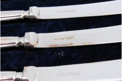 Set of six butter knives with beaded and shell-shaped silver handles
