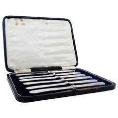 Set of six butter knives with beaded and shell-shaped silver handles