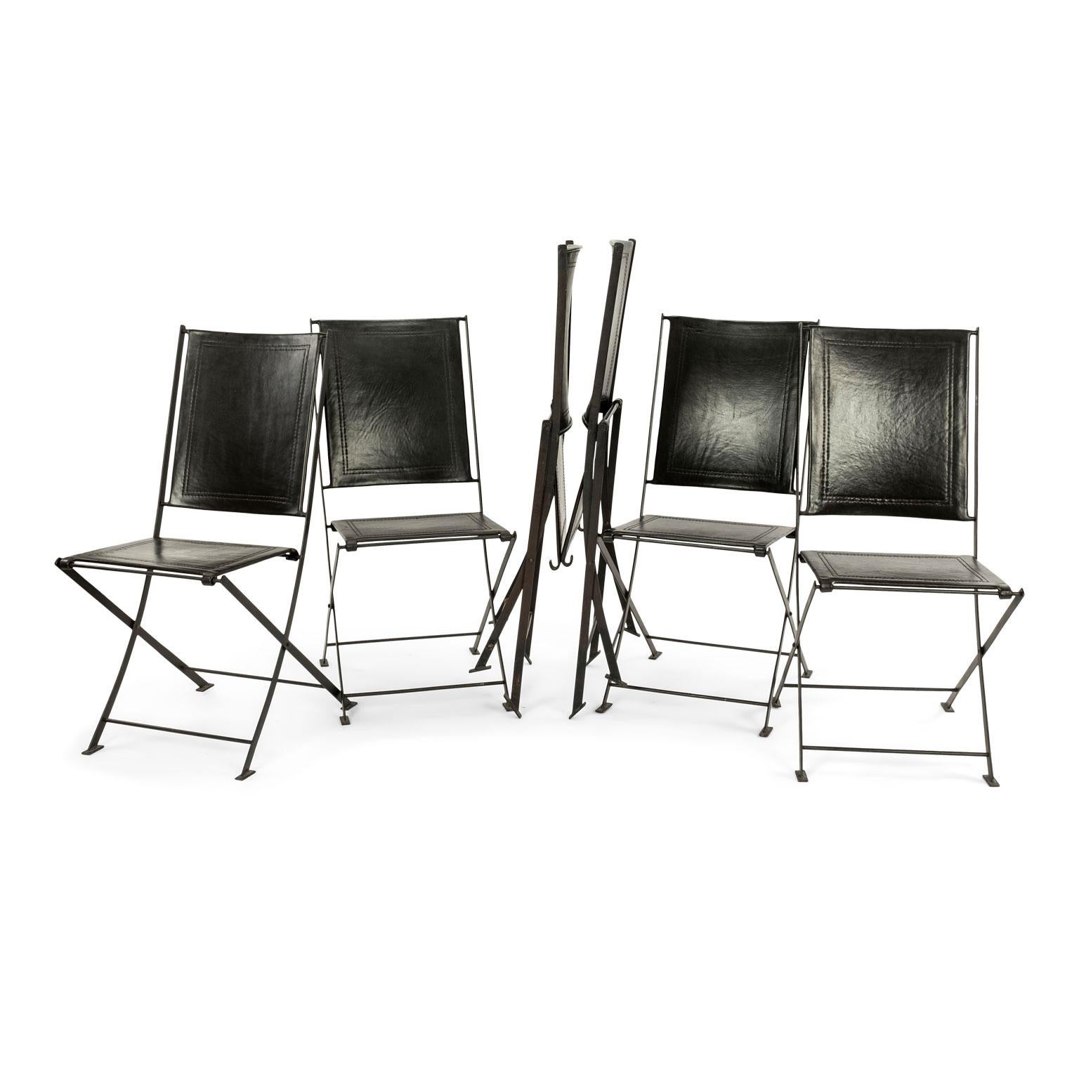 Set of six campaign style leather and steel dining chairs circa 1995-2005. Six campaign style folding chairs, purchased in France. Sturdy forged steel frames upholstered in thick quality dark brown leather. Decorative stitched detail adorns seats