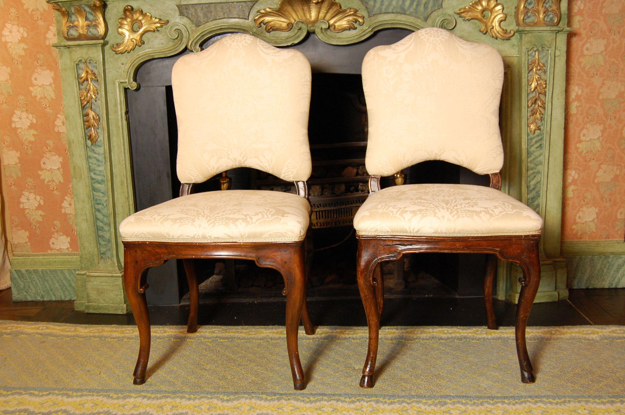 This is a set of six carved Walnut chairs, three of which are 19th century, the remaining three frames were custom-made to match the antique chairs in the late 1990s. Recently recovered in a tone on tone cotton damask. Originally owned by Pittsburgh