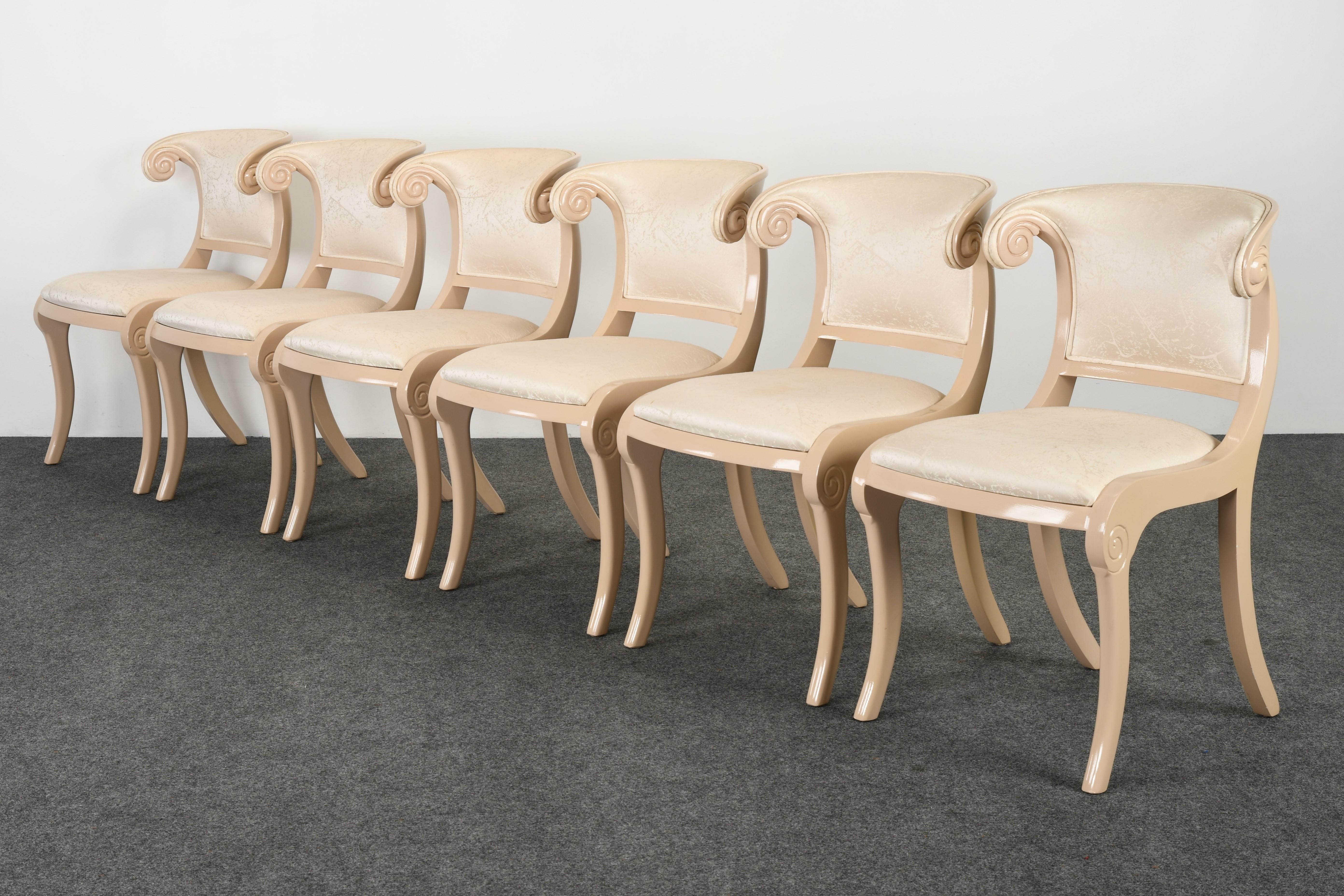 An elegant set of six Casa Stradivari Klismos dining chairs. This beautiful set of chairs is lacquered in ivory paint but would also look good in other lacquer finishes. These wonderful chairs came out of a glamorous spa and estate from the 1980s.