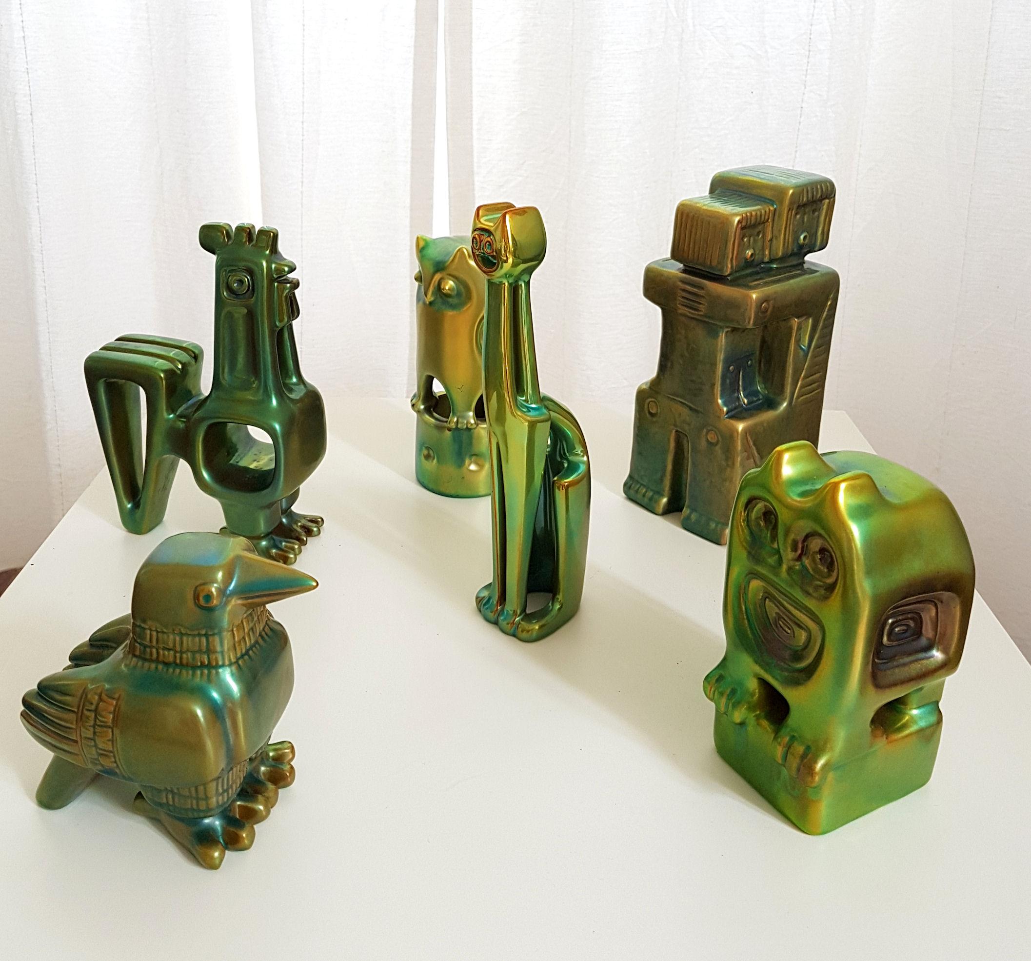 Set of six Mid Century Modern green eosin ceramic figurines, or sculptures by Zsolnay, Hungary.
Artist's Cubic period, with 1960s stamps under each piece.
Each in excellent condition.
Rooster: 7.87 x 5.12 in.
Cat: 9 x 2.75 in.
Mother and child: 9 x