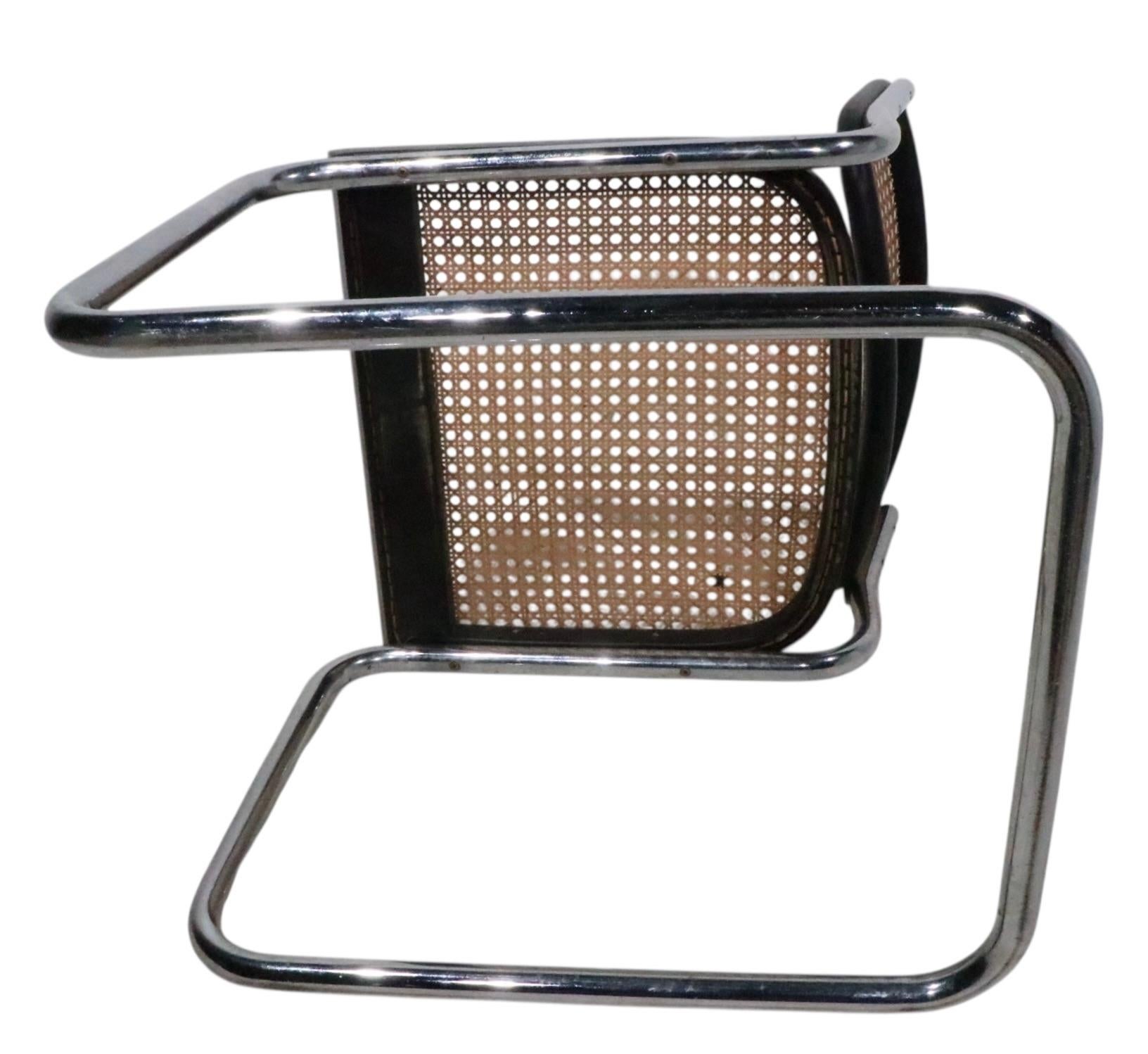 Set of six Cesca dining chairs, designed by Marcel Breuer, made in Italy circa 1970's. The chairs feature bright tubular  chrome cantilevered frames which support the black framed caned seat and back rests. The chairs are in very good, clean and