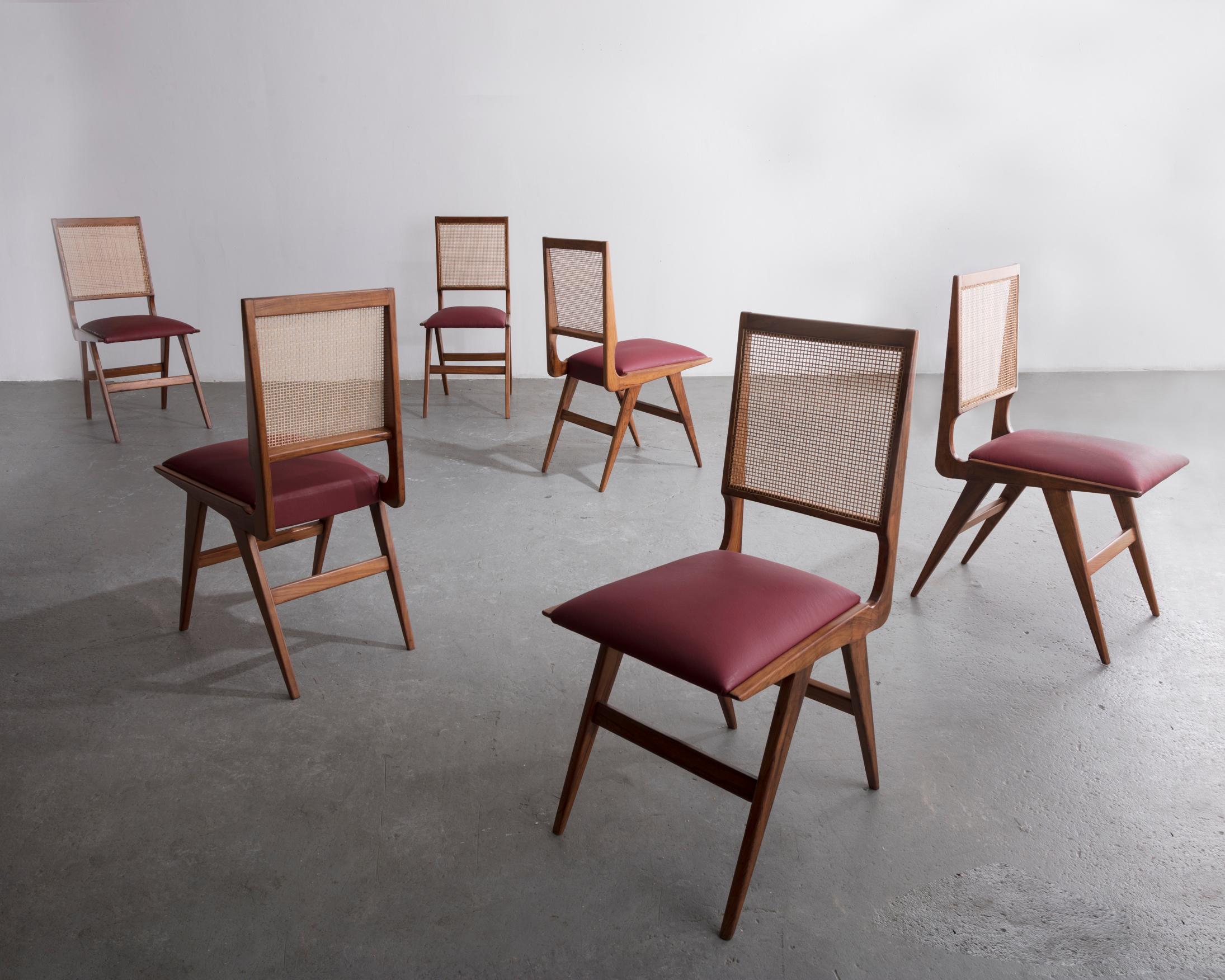 Set of six (6) dining chairs in peroba with upholstered seats and cane backrests. Designed by Martin Eisler for Forma, Brazil, 1950s.