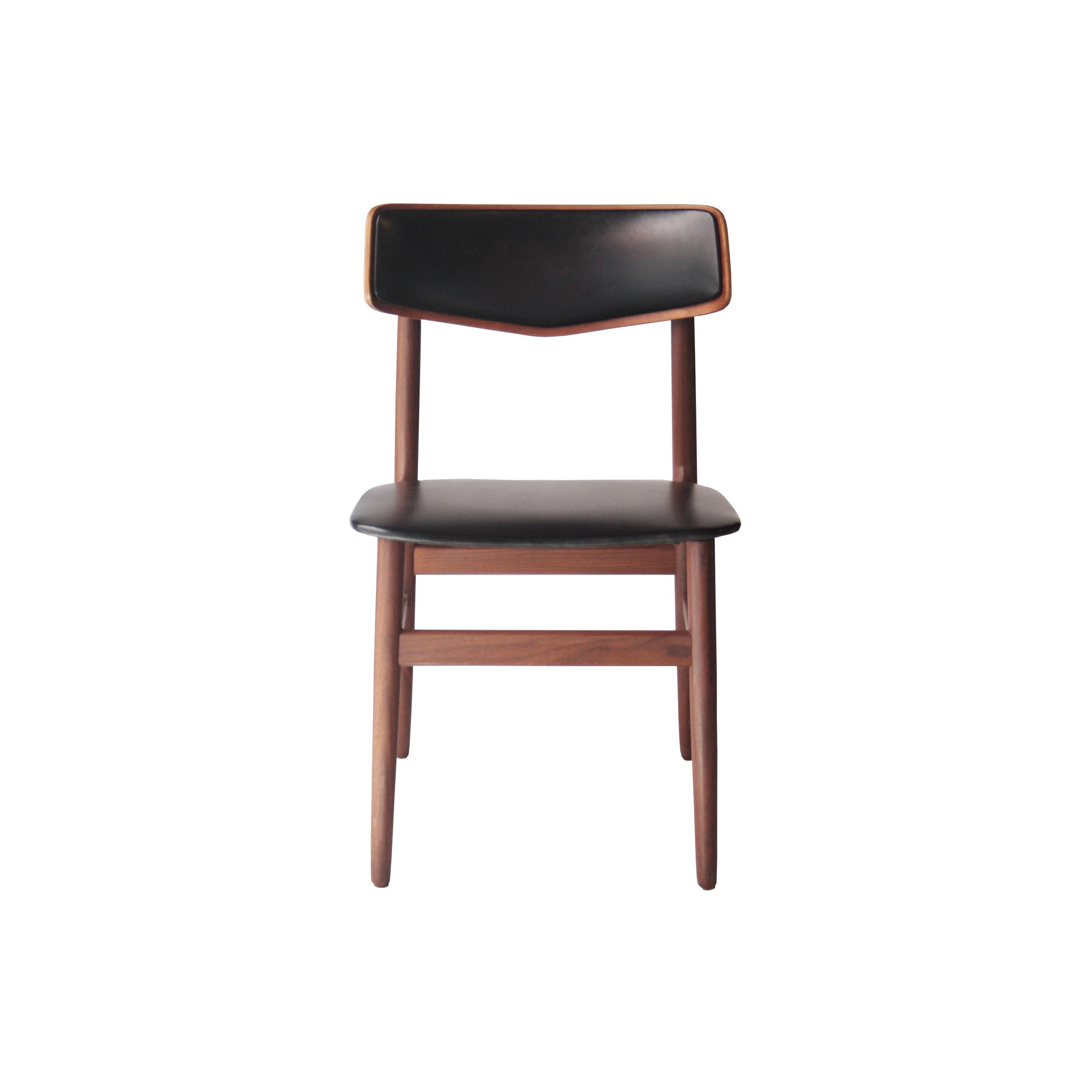 Set of six chairs with solid structure of rosewood with seat and backrest upholstered in black vinyl leather.